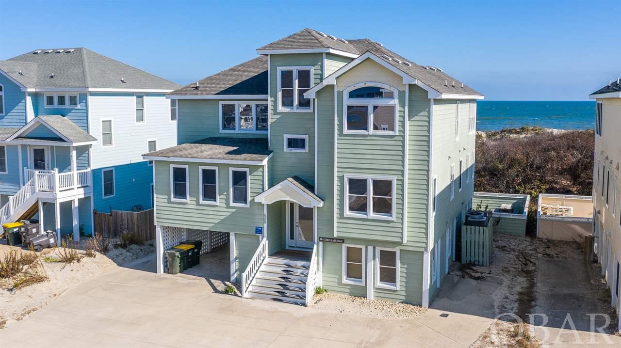 It's no surprise that this quality constructed oceanfront retreat generates strong rental income year after year. The spacious 9 bedroom, 8.5 bath home features a game room with pool table, media room, mid level den with wet bar, elevator, and 7 master suites. Soak up the surrounding ocean views from the top levels greatroom with gas fireplace & entertainment center, ships watch, kitchen with duo appliances, and large dining room. Extensive decks, a private pool & hot tub provide ample space to enjoy time in the sun. Close to all community amenities that include a seven-acre stocked fishing lake, oympic-sized swimming pool, and four tennis courts.
