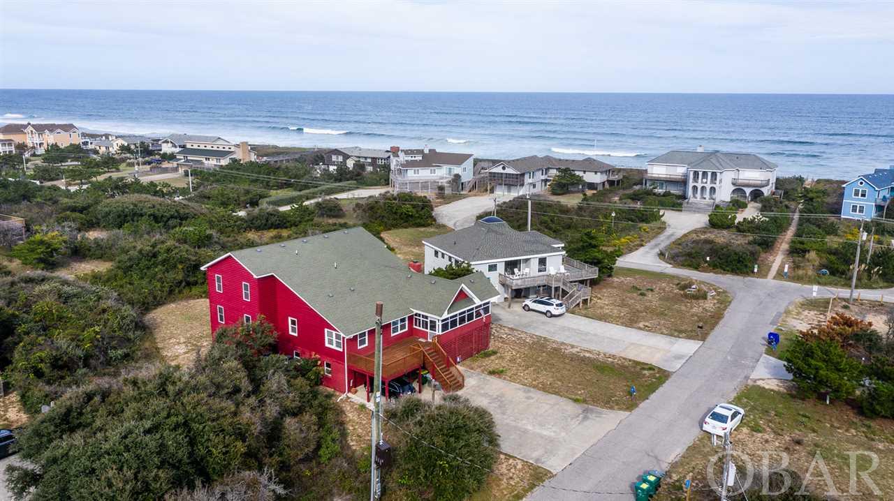 Fantastic ocean views on a quiet dead end street! Home is located 2 lots third row from the oceanfront in the highly desired Sea Crest Village community Southern Shores on. With 7 bedroom  5 2 1/2 Baths, you could find your favorite spot to watch the ocean. The third level Could be the game room/ movie room. This is a property you can truly make home. Owners installed a platform elevator from inside the garage to the second floor no more climbing stairs. The bottom floor has two large storage areas.