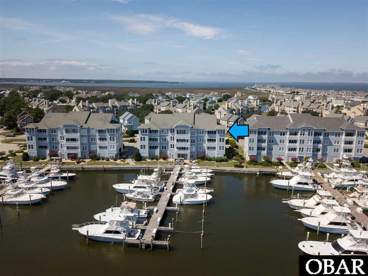 Spectacular Top Floor Condo in Pirates Cove.  Ride the elevator up, step into the front door and immediately enjoy panoramic views of the harbor and the sound. End unit, bright and airy, Condo features over 1700 sq ft,  3 bedrooms, 3 full baths, spacious great room with high ceilings, kitchen with granite, new stainless appliances, brand new flooring, pantry and laundry room.  4 steps up to a beautiful loft with floor to ceiling windows to relax and enjoy watching the boats come and go.  Enjoy sunrises on the back waterfront covered deck, and sunsets from the front porch. Private parking spot and nice storage room underneath.  Short walk to the Tiki Hut and the fabulous Blue Water Grill and Restaurant.  Amenities galore in this waterfront luxury community.  Large pool, tennis courts, picnic area, volleyball, fitness center and a private owners only pool.  Miles of docks for walking or fishing. Sailfish Villas offer privacy with only 9 units in the building, 3 on each floor.  5 minute drive to the ocean.  Life doesn't get much better than peaceful top floor condo living in Pirates Cove!!