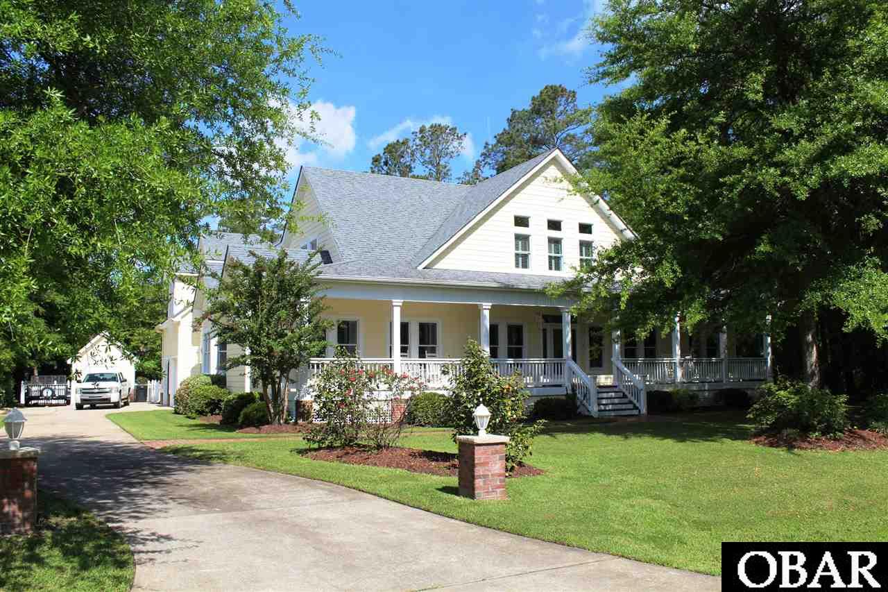 Once featured in the Roanoke Island Club Tour of Homes, this gorgeous, wonderfully designed custom craftsman style home presents 3,767 ft of living space located on ROANOKE ISLAND north on the Sound in prestigious Heritage Point boating community.  Spacious floor plan boasts 9' cathedral ceilings, custom trim, generous living room with gas fireplace, formal dining room off foyer, fully equipped kitchen with Silestone +Ceramic counters, handsome Merillat cabinets, breakfast bar, eating area with bay window seating.  Off foyer is an open office area, bedroom and full bath with special amenities. Huge Master suite has sitting area with bay windows, two sided gas fireplace that opens to sitting area and Master bath to soak in luxury in hearted whirlpool tub. Step outside to screened porch overlooking pool and landscaped back yard.  Spectacular, large foyer entry, staircase to upstairs loft area that opens to the game room below +roomy fitness room with entry to screened porch and pool.  Back staircase off kitchen takes you to open area used as a small game room, a den or home office.  Upstairs are two bedrooms and two full baths; finished room above garage used as 5th bedroom.  SO MUCH ATTENTION TO DETAIL -- 8 zone control HVAC system, interior shutters, wood floors, home office areas, mud room, thoughtful placement of Casablanca + Malibu fans, private in-ground pool, ceramic tiled sunroom converts to screened porch, beautifully manicured yard, irrigation system, outdoor shower, large front porch to enjoy the tranquility outdoors, fenced back yard.  All the details + stained glass is exquisite - this home has every amenity you could ask for!  Beautiful Soundfront marina offers a boat slip assignment for each lot owner!  Community offers gazebo, sandy beach area, fishing pier on the sound.  Short drive to Atlantic Ocean shoreline on the Outer Banks, Oregon Inlet or boat there, walking path connects to Fort Raleigh, Elizabethan Gardens, Croatan Sound maintained by National Park Service.  Ready to live the dream?  You savor your Outer Banks lifestyle with all this residence has to offer!