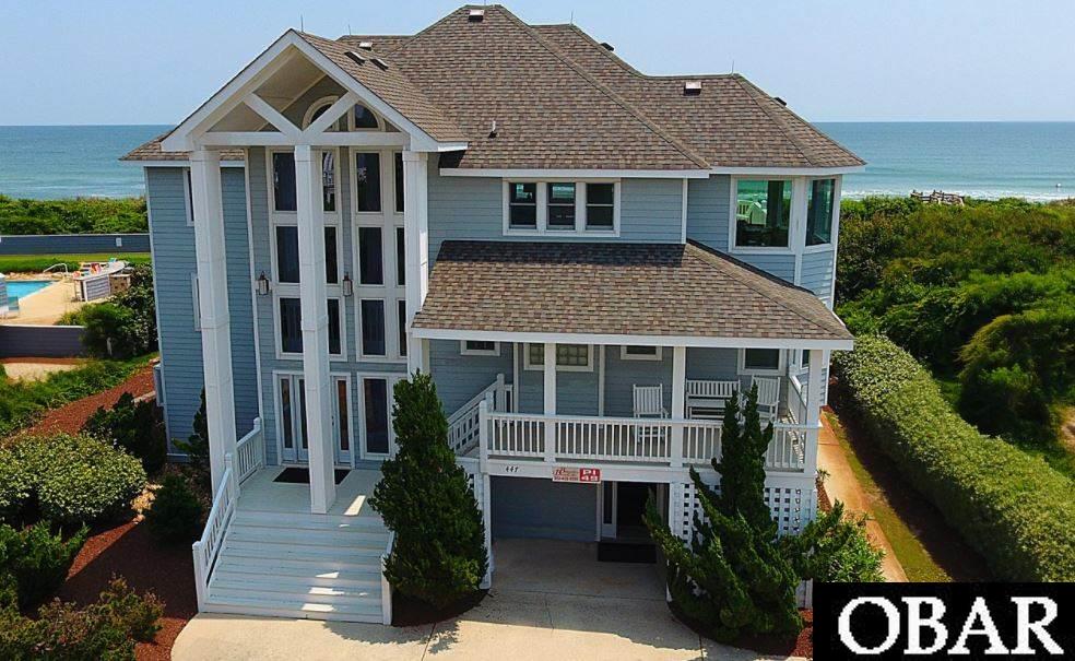 Every single second you spend at this magnificent oceanfront home will reaffirm your belief that dreams really do come true. This immaculate 6-bedroom, 6-bath home, tucked onto a remote cul-de-sac of the coveted Pine Island community in Corolla, is an absolute show-stopper. The generous outdoor living spaces will simply WOW you; from the covered pool area Tiki bar (complete with outdoor fridge), to the secluded hot tub to the amazing firepit that invites warm fireside chats to the meandering walkway that leads you to the pristine beach - all of this backdropped by unending views of the mighty Atlantic Ocean. After relaxing, lazy-filled days spent poolside or on the beach, move into the lower level and challenge someone to a game of pool OR challenge your own prowess in one of 30 to 40 games loaded onto the cool Arcade machine just installed this year. This bottom level also boasts two bunk rooms, a full bath and a laundry room. Moving up to the mid level you'll find three more spacious bedrooms, two with their own baths, a family room equipped with its own mini-kitchen, a foyer and a hall bath. Note that custom Italian tile flooring was recently installed throughout and there's also a covered deck to enjoy the ocean views and soothing salty breezes. Move on up to the top level and make sure you exhale after your first glimpse of nothing but ocean and sky. The larger than life windows are perfect and the views absolutely stunning. The open concept living area is grounded by beautiful hardwood oak floors that contrast perfectly with the slate-colored tile surround of the gas fireplace and the designer black and white, perfectly appointed kitchen (there's a second dishwasher and a wine cooler!) with stainless steel appliances. The look is flawless from the high-end furniture and decor to the moving views of ocean and sky from every angle. There's a designated cozy breakfast nook and gracious dining area, and the granddaddy of all bedrooms is up here, too, with its own recently and tastefully updated bath, plus private entry to the outdoor sun deck. We all literally swooned when we saw this house and know you will, too! It really is Treasure Island.