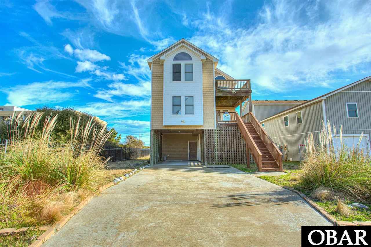 Lovingly maintained and rarely used oceanside home just a 90 second walk from the ocean. Close to restaurants and centrally located on the OBX, this house has great views of the Wright Memorial. New flooring and a private pool, game room, tiki bar, and 2 master suites .  Mid level has 3 bedrooms and 2 full baths.  Third level with kitchen, great room, master bedroom/bath, and decks with views of the ocean.  This is a must see! Owner limits the rentals, this home could do more.