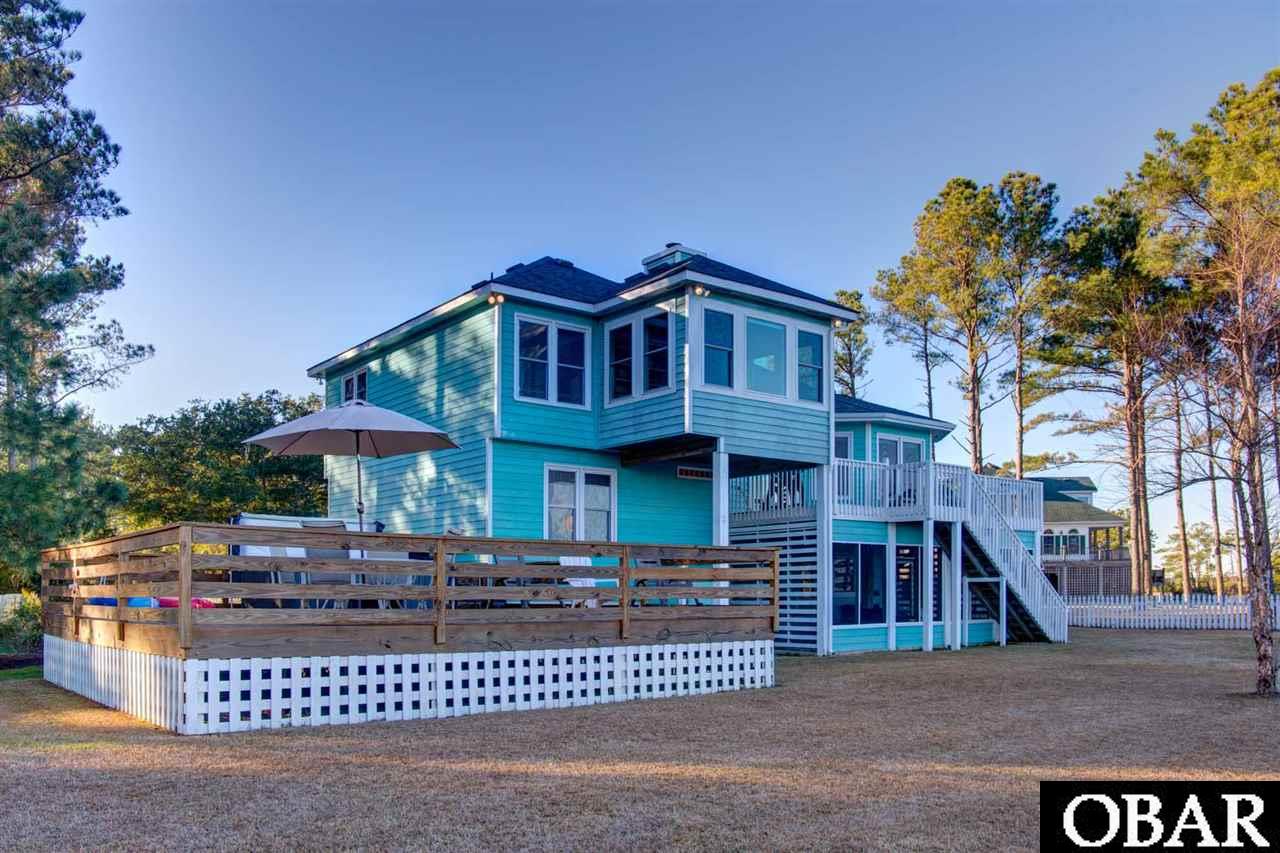 Waterfront Dream *  Lifestyle points are off the chart with this well maintained canal front home on the South End of Manteo * Large, open back yard with nearly 120' of bulk headed shoreline with boardwalk * From anywhere in your back yard or the east side of the home...The View goes on for miles as you gaze over canal, creeks, salt marsh, and open sound *  This is a paradise for the bird watcher, the nature lover, the boater, and the fisherman *  Drop your boat from the 7,000 lb boat lift (2 years old - LSI) and you are off for a day of adventure on the water * Or just sit on your deck and soak it all in * Serenity on a daily basis *  Perfectly located for a trip to the Outer Banks beaches (5 minute drive) or a day of shopping and attractions of Manteo...The Waterfront, Festival Park, NC Aquarium, Lost Colony, Elizabethan Gardens, Fort Raleigh, Roanoke Island Marshes Light and The Maritime Museum * Well for irrigation * Recently installed portable generator (Beacon Electric) that powers refrigerator, microwave, WIFI, and lights in master BR, living room, dining room, guest bedroom and ground level rooms * Awesome screened patio * Do not miss this one!