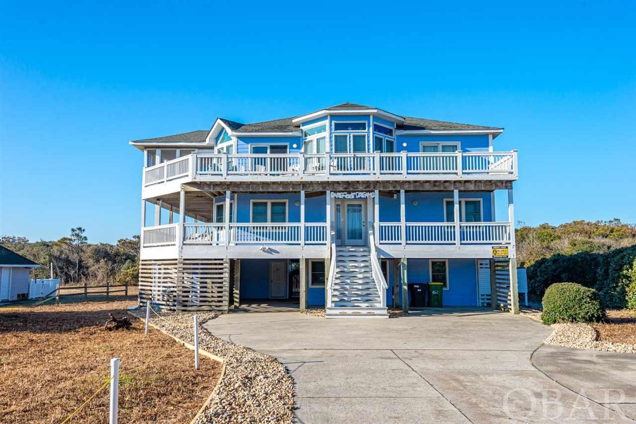 It's beach time! Come be part of the Southern Shores scene. The community has a lot to offer including access to the beach and sound. Check out this six bedroom home, three of which are Masters along with 5.5 bathrooms. The top level is a welcoming open floor plan with views of the ocean and easy beach access across the street. Need to get out of the midday sun? Right off the living area there's a screen porch catching breezes on three sides. This house also has ample decking on two levels. The backyard has a 16 x 34 pool to accommodate the whole family along with a hot tub. The second living area allows a space to watch TV or chill out in-between activities. Once you cross the bridge over Currituck sound, you're less than two miles away to 61 Ocean Blvd to start enjoying the Outer Banks...