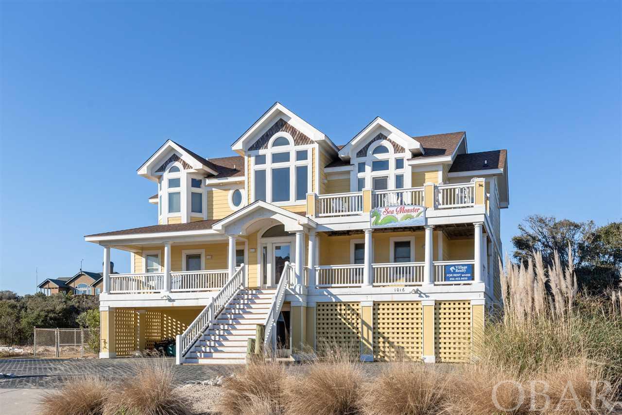 Amazing ocean views await the new owners of this large 8-bedroom, 8.5 bath semi-oceanfront home in Whalehead.  Quality built with large gatherings in mind, the property features over 5300 Sq Ft of heated living space.  Cathedral ceilings, an open flow reverse floor plan with top level en suite bedroom, and multiple gathering spaces make “Sea Monster” a favorite with vacationers.  Added features such as granite counters, custom tilework, hardwood flooring, a screened porch, elevator, midlevel with 4 more en suite bedrooms and a bonus media/family room, and a ground level with 3 more en suite bedrooms and rec room with kitchenette, are just a few of the appealing interior features.  Extensive decking offers ocean views from the east elevation and views of the 33’x12’ pool & hot tub and volleyball court from the west elevation.  The pool area even has an outdoor wet bar where guests can relax in the shade of the Cabana.  If your buyers are looking for a rental investment boasting quality touches, ample square footage, an intelligent floorplan, and amazing views… this is it.  Located on a large lot in an X flood zone and close to the beach access make this property the one to see!