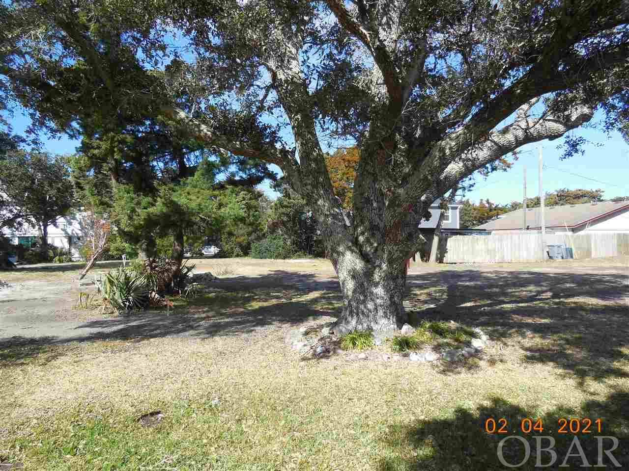 A 5297 sq. ft. lot in Live Oak Village, a new 7 lot subdivision in the heart of Ocracoke Village. A beautiful live oak stands tall and proud on this property. Conveniently located, close to all the island attractions. Bike or walk around the village, or take the tram. The tram stop is right around the corner for those busy summer months Choose from many coastal classic house designs! Restrictive covenants in place to maintain the historic charm and quaintness of Ocracoke Village.
