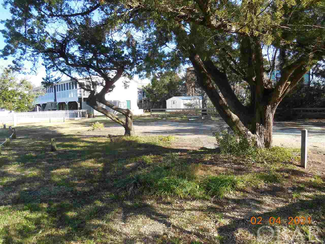 Ready to build!!! A 5163 sq. ft. lot in Live Oak Village with an installed 4 bedroom gravity flow septic system and 4 bedroom/4 bath water meter. This property has mature trees and native vegetation. Cleared and ready to start the building process. Choose from several coastal home designs. Restrictive covenants in place to retain the historic charm and quaintness of Ocracoke. Taxes are an estimate only. Currently being taxed as one large parcel.