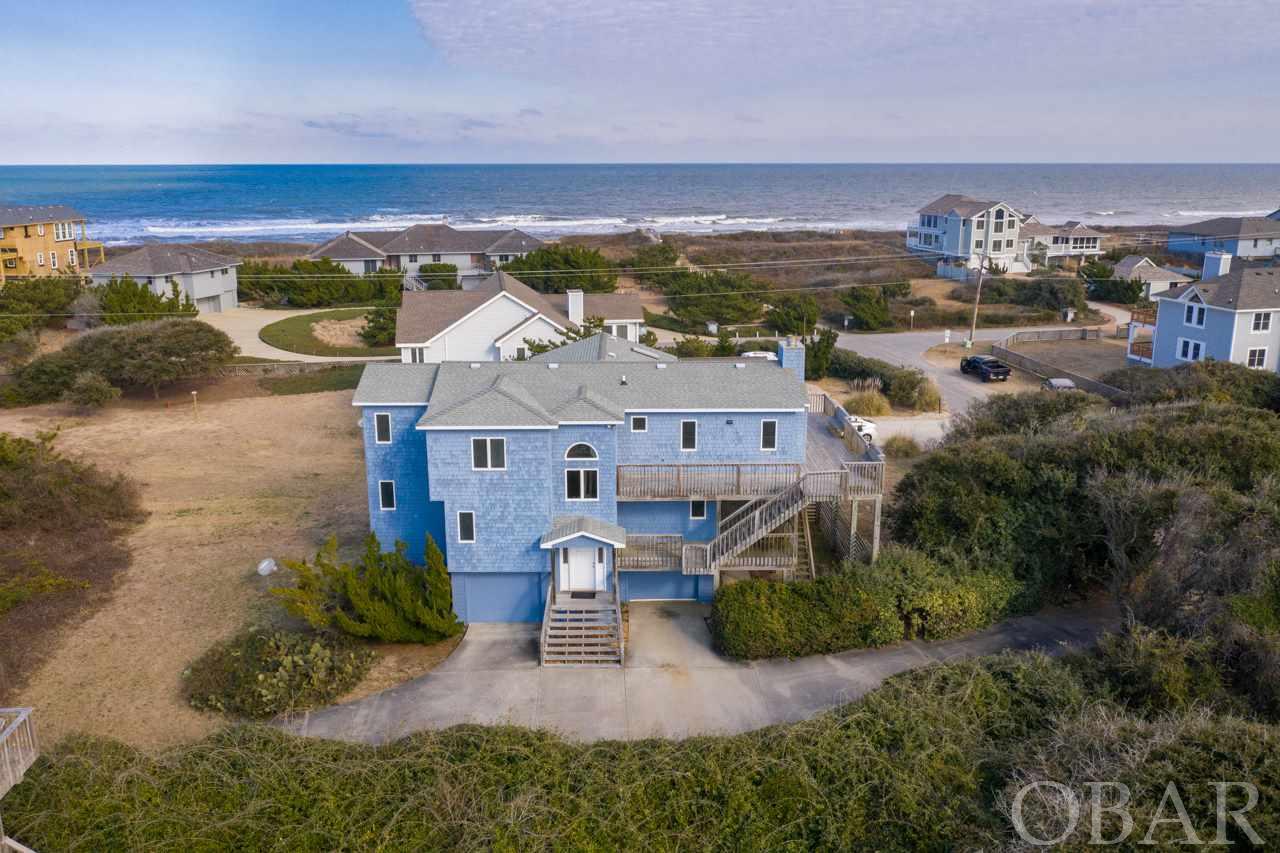 Paint your masterpiece in the best location on the Outer Banks! This home on Thirteenth Avenue has all of the benefits of Southern Shores (easy year round access, private uncrowded beaches, marina access, tennis courts, walking trails) and is adjacent to the town of Duck and is in walking distance to downtown. Outstanding ocean views and access await in this incredible location! Only one owner has ever lived in this well built home. It has never been rented. The layout is perfect for personal use with a large, open living area that features captivating ocean views, hardwood floors and ample storage.  There is plenty of room for a pool on this secluded, private  27,000 square foot site.  It has abundant potential to be a fantastic rental given the prime location just steps from the beach.
