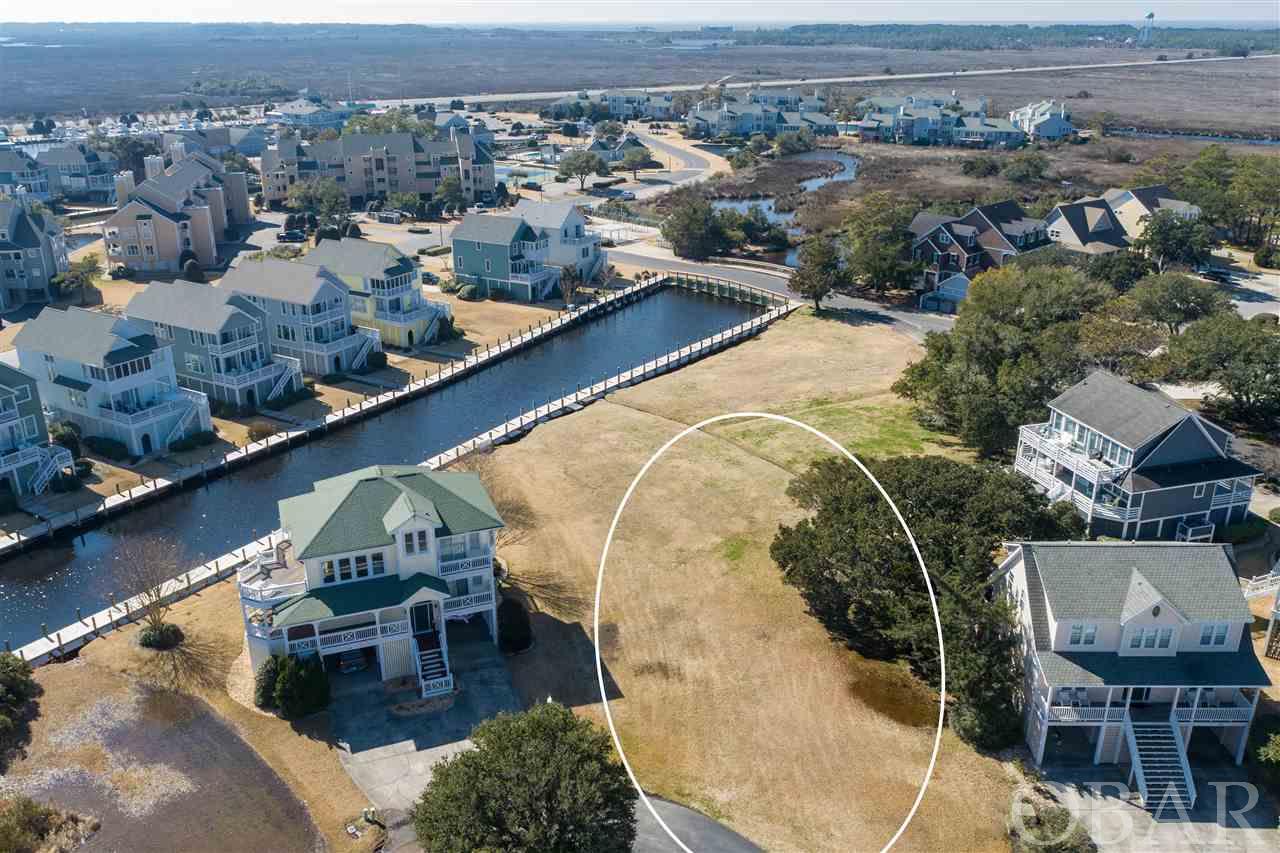Only a few lots remaining!  Located in the Spinnaker Village cul-de-sac of Pirate's Cove, this canalfront .23 acre lot offers location value and easy sound access and conveys a 55FT boat dock to qualified boat owners.  Golf-cart friendly, the Pirate's Cove community amenities include:  swimming pools, tennis courts, clubhouse, fitness center, on-site restaurant, world-class fishing marina and 4 miles of perimeter docking perfect for walking or fishing.  Prime opportunity for a potential investment property or second home, this lot location is only minutes from the beach and local attractions.