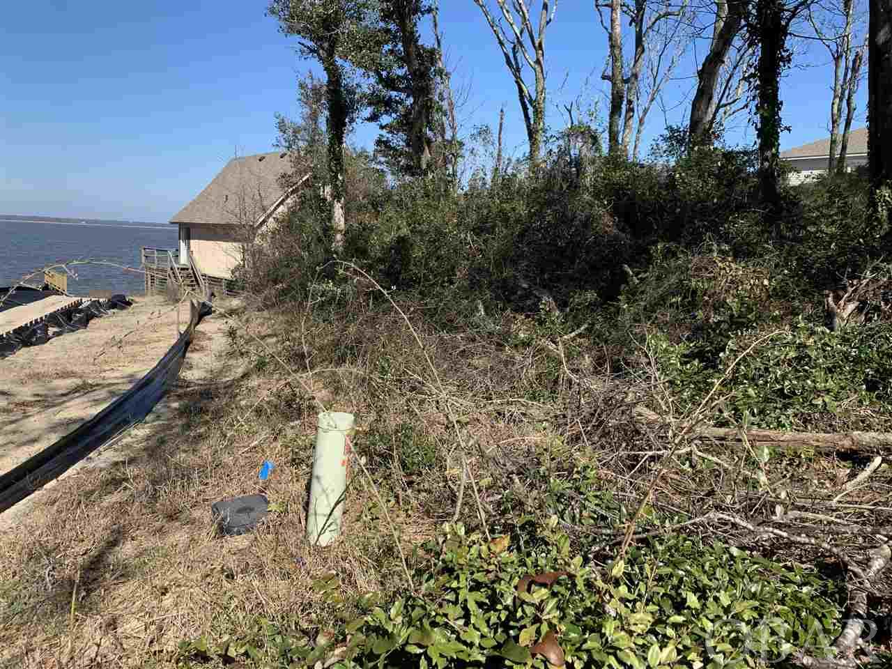 PRICE REDUCED!!!!  Enjoy spectacular water views overlooking the scenic and lovely Kitty Hawk Bay!  Outstanding WATERFRONT site located in the boating community of Colington Harbour!! Build your Outer Banks dream home on this elevated site and enjoy panoramic water views! And sunset views!  Situated on a quiet cul-de-sac in a very private setting just a short stroll to the community amenities! Community amenities include: Clubhouse, marina, boat ramp, sound front beach / park with swimming area, Olympic size salt-water pool & baby pool, tennis courts, gated community. *Small old structure on the property to be sold in "as is where is" condition. No access to structure is available. Bulkhead in place. no site prep needed. Owner financing may be possible for a qualified buyer.
