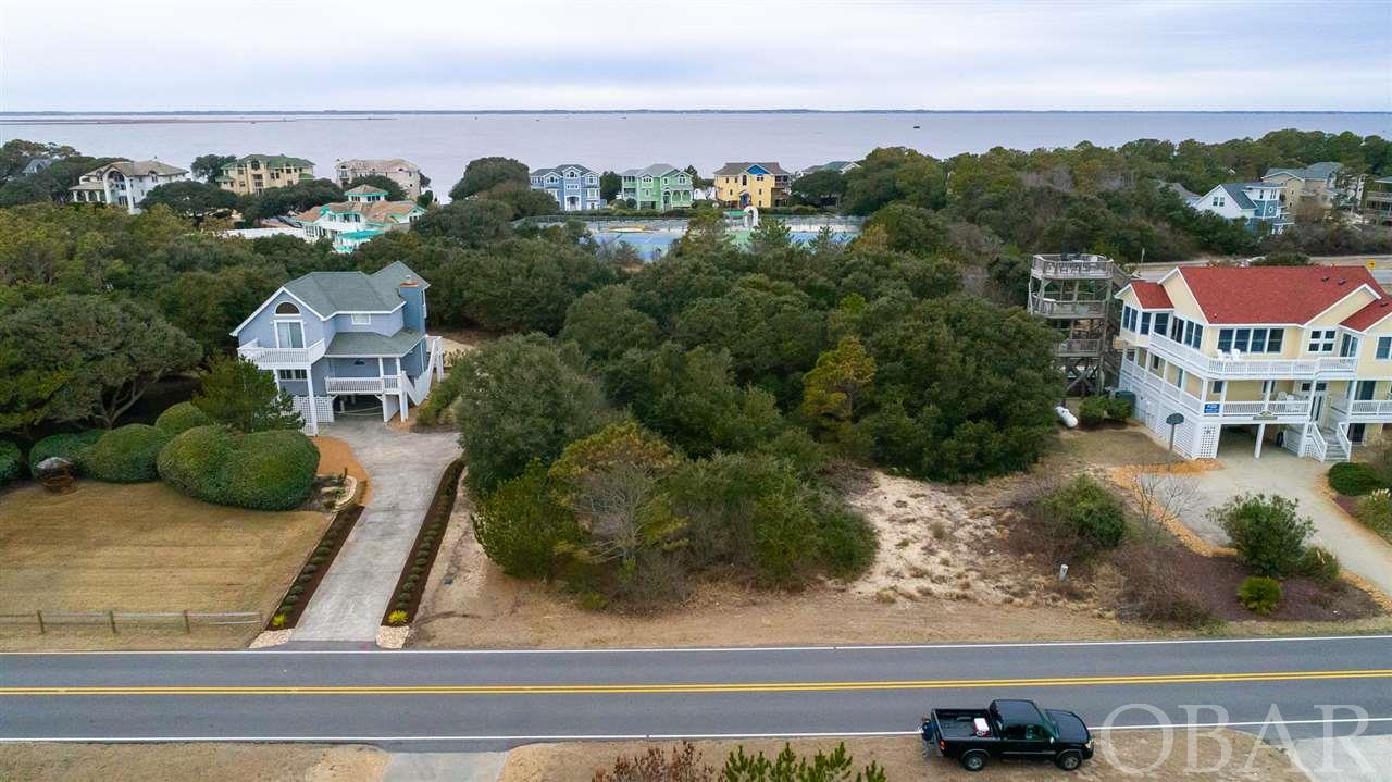 The most affordable lot in the sought after Whalehead neighborhood in Corolla!  This 6th row lot is only 3 lots away from the Bonito Street beach access, making it a quick walk to the beach.  Build your dream vacation home on this 20,000 sq/ft lot located in an X-Flood Zone. Flood insurance will not be required.  Beautiful ocean to sound views are possible depending on your future build. Enjoy seeing dolphins in the morning and soundside sunsets in the evening.  Centrally located in Corolla, you will be close to popular shops, restaurants and attractions.