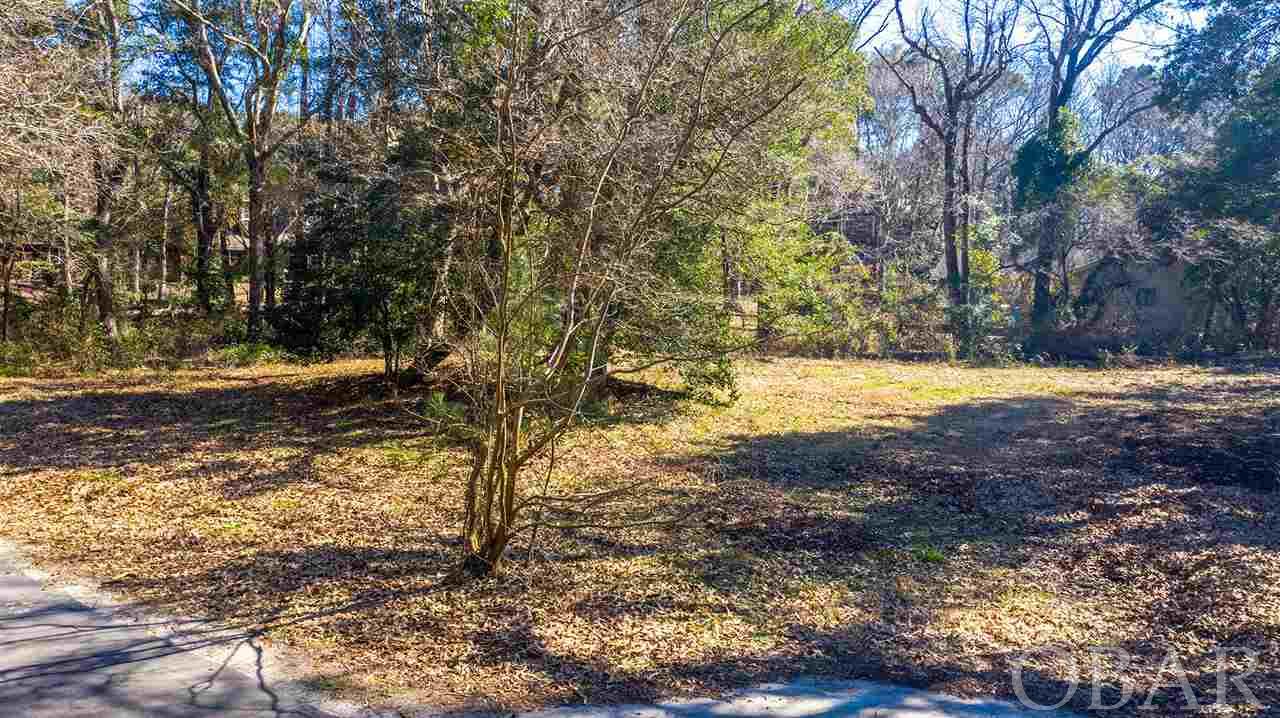 Prime building site consisting of over 20,000 square feet located in an X flood zone. This corner lot tucked in the woods of Southern Shores offers minimal lot preparation for new construction. Walk to the beach or take a bicycle ride and enjoy the peacefulness of this year round community. WATER TAP FEE PAID AND ON SITE. See broker's notes for disclosure.