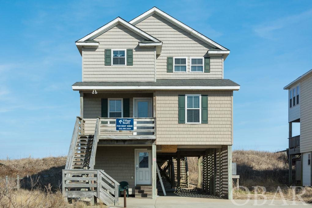MAGNIFICENT OCEAN VIEWS from both the top and mid levels of this charming beach house. Renters love this house and after sitting on the covered porch, you will want to make this your own beach home. A long protective dune has a private walkway to the beach. New hot tub in 2019. There are 4 bedrooms, 3 full baths and a private den added in 2018 making this house a rental machine. Relax in the hot tub and enjoy the waves lapping the beach. Soak up the sun on top deck or seek retreat in the shade of the covered porch. Conveniently located in Kill Devil Hills, easily walk or bike to restaurants, shops, movies and recreation spots. Well maintained and being sold fully furnished. See Sellers Information Document for recent updates.