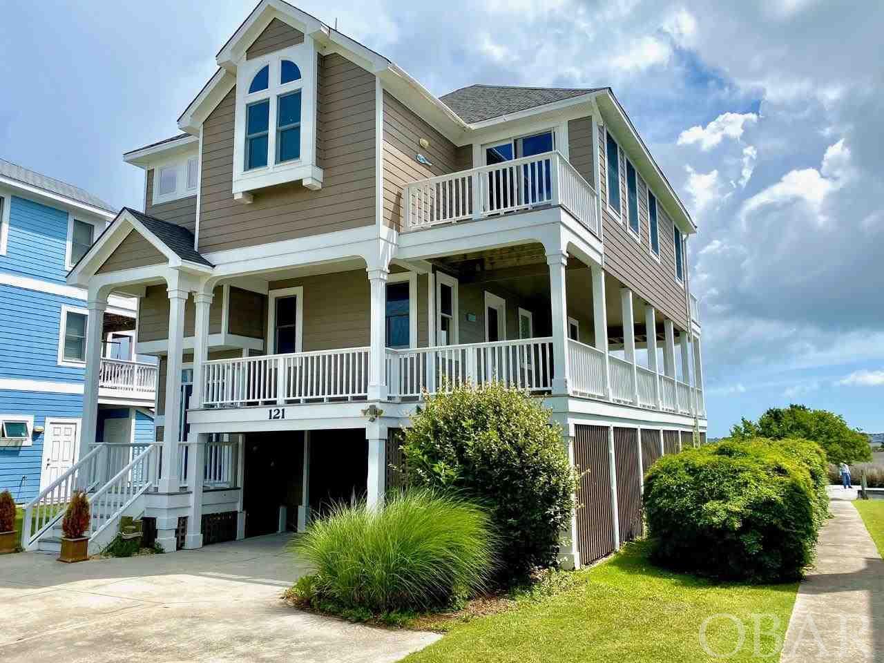 Looking for a canalfront home, look no further! This beautiful canalfront home with approximately 50ft of dock/boardwalk in the Peninsula subdivision of Manteo is the perfect home for morning sunrises. The Peninsula is a hidden gem offering seclusion and tranquility just minutes from downtown Manteo. This home boasts two masters, one on each level. It features stained glass overhead lighting in upstairs master and living room. The living room's gas fireplace is surrounded by floor to ceiling stone. New interior paint, new dishwasher, new refrigerator, new oven/range, new microwave all in 2021, roof 2019, exterior paint 2018.