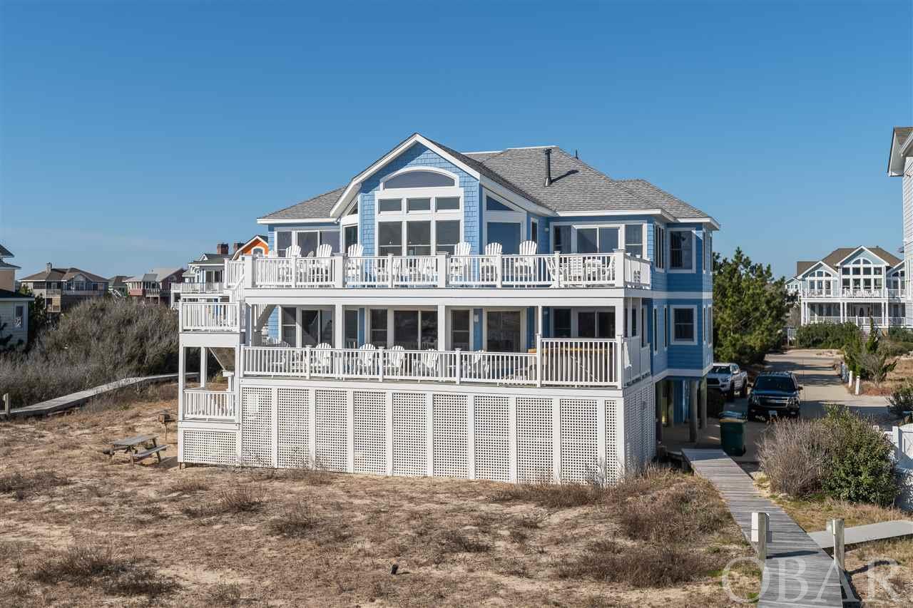 OCEANFRONT BUCK ISLAND HOME HAS THE  BEST VIEWS OF THE OCEAN. THIS HOME IS BUILT WITH THE POOL TO THE PROTECTED WEST SIDE OF THE BUILDING. THIS HOME IS LOCATED WITH DECKS AND GRAND WINDOWS CLOSEST TO THE OCEAN BY REVERSING THE POOL. YOU CAN SEE THE ENTIRE BEACH SAFELY FROM THIS UNIQUE SETTING.  BUCK ISLAND IN COROLLA HAS BAR NONE, 82 OF THE FINEST HOMES WITH MORE AMENITIES INCLUDING THEATER, AN  ELLIGENT VILLAGE TYPE SETTING. ALL HOMES HAVE A PAINT RESERVE. THIS KEEPS THE COMMUNITY IN TIP TOP CONDITION. This is the Premier Top Shelf Community in Corolla. Steps to Shopping & Restaurants. Located in a Gated Community with all the features for the discriminating Renter. This 5690 square foot home features home theater. 7 large bedrooms with 6.5 bathrooms modern kitchen, a huge master suite. Fully furnished with quality pieces.  MODERN VINYL MAINTENANCE FREE RAILINGS ON DECKS. NEW HURICANE RESISTANT SHINGLED ROOF.   Large Kitchen with granite counter tops. A west afternoon facing pool for that late afternoon swim. All of this on the best maintained beach in Corolla. The community has tree lined streets with sidewalks and street lights. Parking by the Beach as well as Children's Play area another community pool and tennis courts. OWNERS USE HOME 0NE SUMMER WEEK! ONE WEEK RENTED TO BY OWNER NOT SHOWN. TWO WEEKS STILL THAT WILL BOOK.  This Home will easily hit $250,000 in rent this Season. BEST COMMUNITY, GREAT OCEANFRONT HOME. IN COROLLA. Silicon Travel and Spectrum boxes do not convey.
