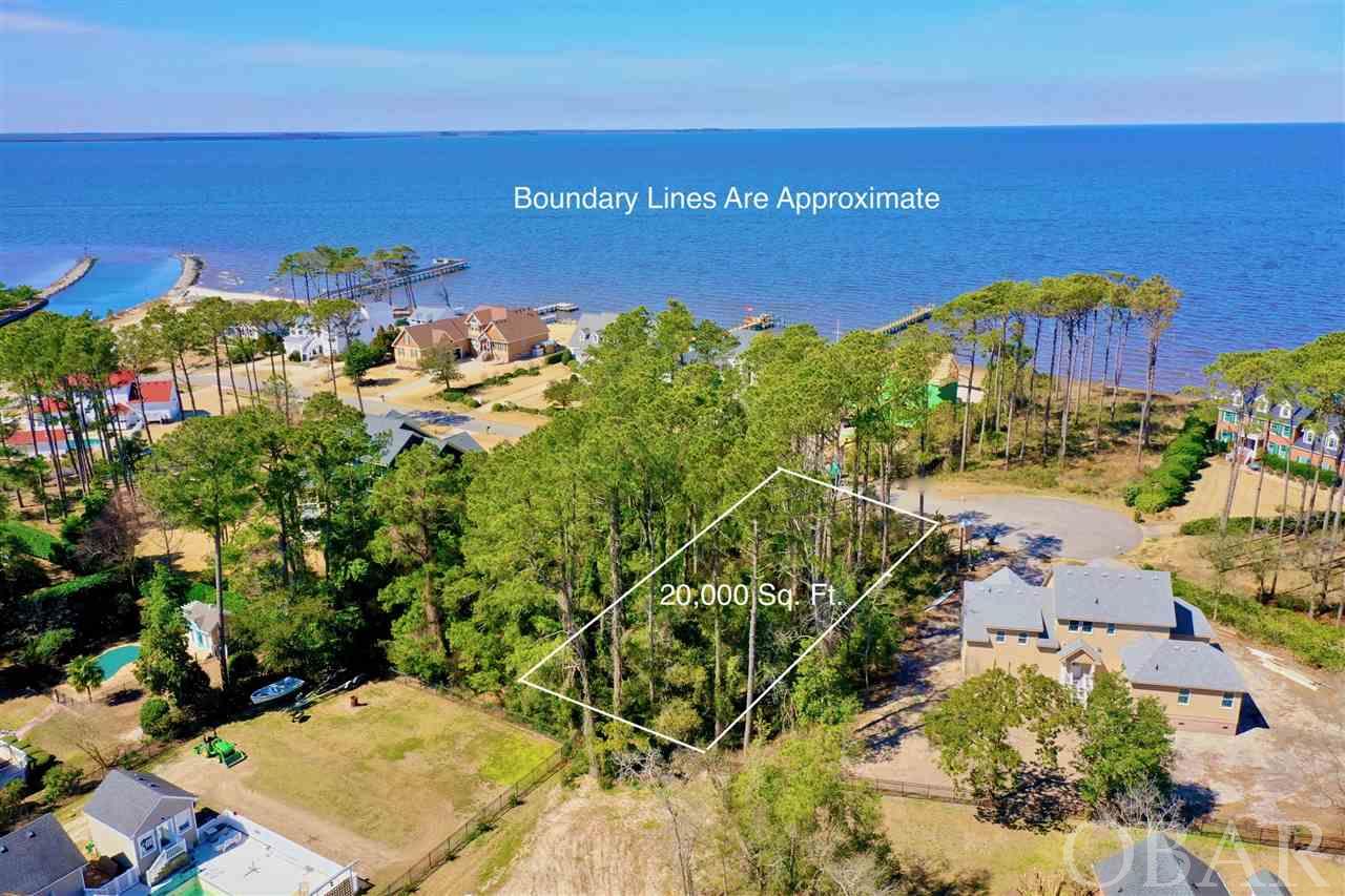 Rare opportunity to own one of the few Semi-Soundfront homesites available on Fort Hugar Way in the exclusive boating community of Heritage Point. Property conveys with a boat slip at no extra cost. This 20,000 sq. ft. lot is located at the end of a quiet cul de sac, with potential to have amazing sound views offering the most stunning of sunset vistas. Perfectly situated between 2 soundfront properties allowing for better views. Enjoy the glorious backdrop of nature on Roanoke Island where the town of Manteo carries a strong sense of heritage and lends an idealistic lifestyle with focus on family and community unity. Build your forever home on this lot and enjoy making memories with your family. The community sound beach with gazebo and pier are just steps away where you can enjoy fishing, crabbing, kayaking, paddle boarding, stargazing or watching spectacular sunsets. Or take advantage of the other amenities the community offers; sound access, marina, boat slips, boat dock/launch, club house with exercise facility, and tennis courts. Heritage Point is conveniently located and in close proximity to the Fort Raleigh National Park, Lost Colony, Elizabethan Gardens, North Carolina Aquarium, Festival Park and Downtown Manteo which can be accessed by the miles of walking/biking trails that stretch throughout Manteo. Enjoy the best of both worlds; the privacy of Heritage Point and proximity to OBX beaches & attractions.
