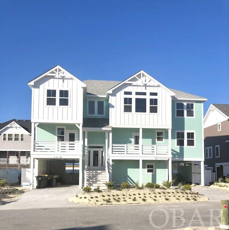 Over $160,000 booked already for 2021! Anticipating over $180,000 for 2021! Spectacular brand new seven bedroom home in Ocean Sands Section O; brand new for 2021 season. Elevator access to all levels. All of the seven bedrooms have private ensuite baths. Check the surf from the ocean views on the top floor.  Beach access is less than one minute walk. This house is a top producing rental with all of the amenities for discerning guests. High quality composite smart board exterior siding with custom trim. Interior is custom trim with high end furnishings. Loaded with extras. Smart home wired throughout; locks, thermostats, Sonos sound system with speakers inside and out, all Samsung Smart televisions. Three level home, the ground floor has elevator access, half bath, large rec room with wet bar and full size counter depth refrigerator, and double laundry room (two washers/two dryers). Second level has five total bedrooms two kings, one queen, two twins and built in bunks with built in televisions.  Several with private decks or access to shared deck overlooking the pool area.   Top floor has another two king masters with private bath and walk out covered deck.  Private den with built in twin and twin trundle, powder room.  Kitchen has stainless steel appliances, coffee bar, gas range with commercial hood; two dishwashers, two full size counter depth refrigerators.  Adjacent dining with seating for 14 at the table and another seven at the large island. Multiple covered decks provide shade and a great spot to sit and enjoy a meal. Large private heated pool, vinyl fenced with large turf lounge area, poolside television, and paver area with covered shaded tiki bar with bar sink.  Hot tub in pool area.  No detail has been over looked in this house.  House will convey with a required two year management agreement with OBHOA, LLC.