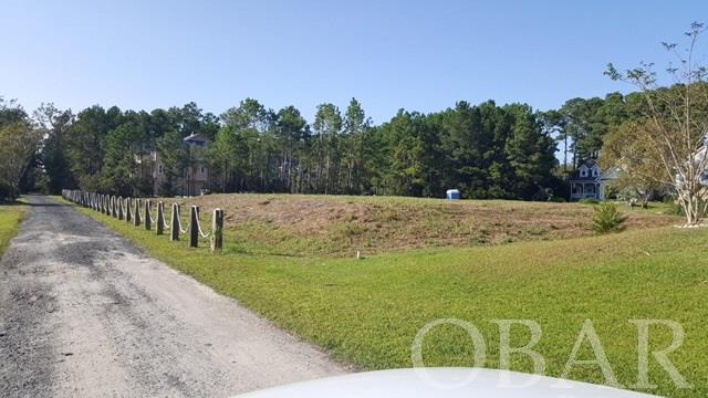 Cleared and filled lot on the North End of Roanoke Island.  Residential Dare County  Building Permit on file for 3 bedroom/3 bath, 2595 square foot home along with survey showing proposed home with septic system.   Water assessment and meter impact fees have been paid. Seller has paid invoices showing almost 200 loads of fill on property.  This will allow an elevated home to take advantage of the sound views across the street. Lot is totally cleared to give a buyer the opportunity to design their own landscape plan. Great quiet, cul de sac, neighborhood.  Walking/ biking distance to NC Aquarium, Roanoke Island Airport, and Dare County Swimming Hole/ Park. This property will make the most beautiful site for your custom home!