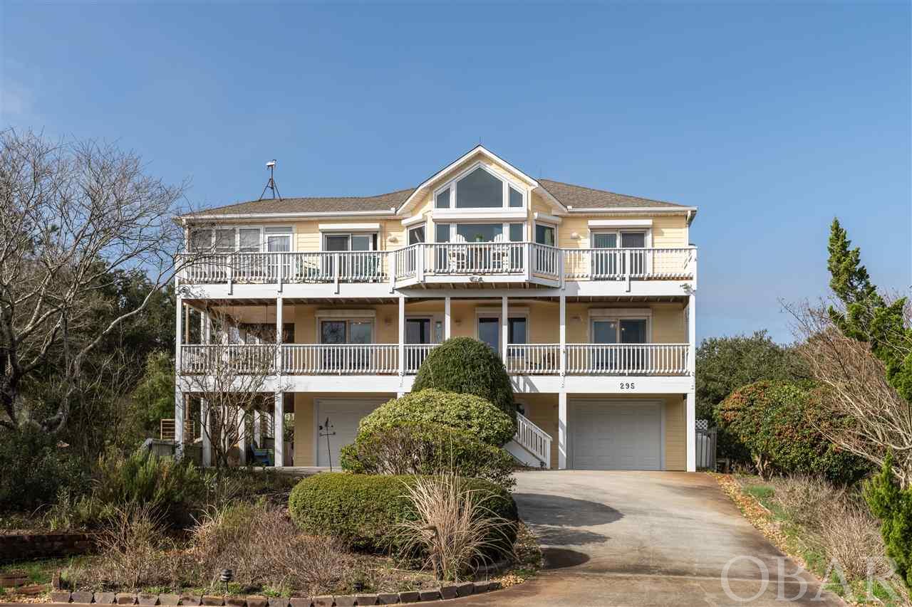 Check out this Fantastic Southern Shores Cottage with the Million Dollar View!  If you like Gorgeous Ocean Views and beautiful everyday sunrises, and sunsets, this home is for you!   This 2,900’ Southern Shores Westside Five Bedroom/4.5 Bath home is an Exceptionally well-built home that has been well maintained over the years! The builder customized this home with wainscotting throughout, Ceiling fans in most rooms, all solid wood doors, and the best windows you could buy to show off the most spectacular OCEANVIEWS.   I asked the sellers about their home and was told it took them two years to find their “perfect house” and once they saw this one, they never looked back.  Sitting on a half-acre lot this Classic Dune Top home sits back on the lot surrounded by beautiful low maintenance natural landscaping and outside lighting.  If you love the outdoors at the beach, we got you covered here with a sizeable covered wrap-around deck with a hot tub area, sundecks looking out at those gorgeous ocean views, a covered deck for grilling right outside the kitchen door and two outdoor showers.  Top floor has an open floor plan with Cathedral Ceilings, Oak hardwood floors throughout kitchen, living, dining and master bedroom.  Living room has a Custom Stone gas fireplace and windows from wall to wall.  Spacious kitchen with double size pantry, sit at bar and gas stove.  Sunroom with tiled floors and wall-to-wall windows.  Top Floor Powder Room.  Master Bedroom with ocean views!  Walk in Closets, double vanity sinks, jet tub.   Mid-Floor has a large tiled Foyer with another master suite plus three bedrooms and a large bathroom. Laundry closet, and two other large linen closets.   You will find your Game Room on the ground floor with another full bath and entrance to the carport and two garages.  Now that you took a tour of the house, come visit and check out the short walk/bike ride to the beach, just a 12-minute walk. Very close to Hillcrest beach access which is an easy street to cross.    This home and location are guaranteed to make you fall in love at first sight!   Extras you don’t see in all homes:  Tinted Windows on all the front windows, Electric storm shutters on the East & North facing windows, House is wired for a 7500 watt generator, stair-master that holds up to 400lbs from ground floor to top floor, irrigation system and lightning rods.