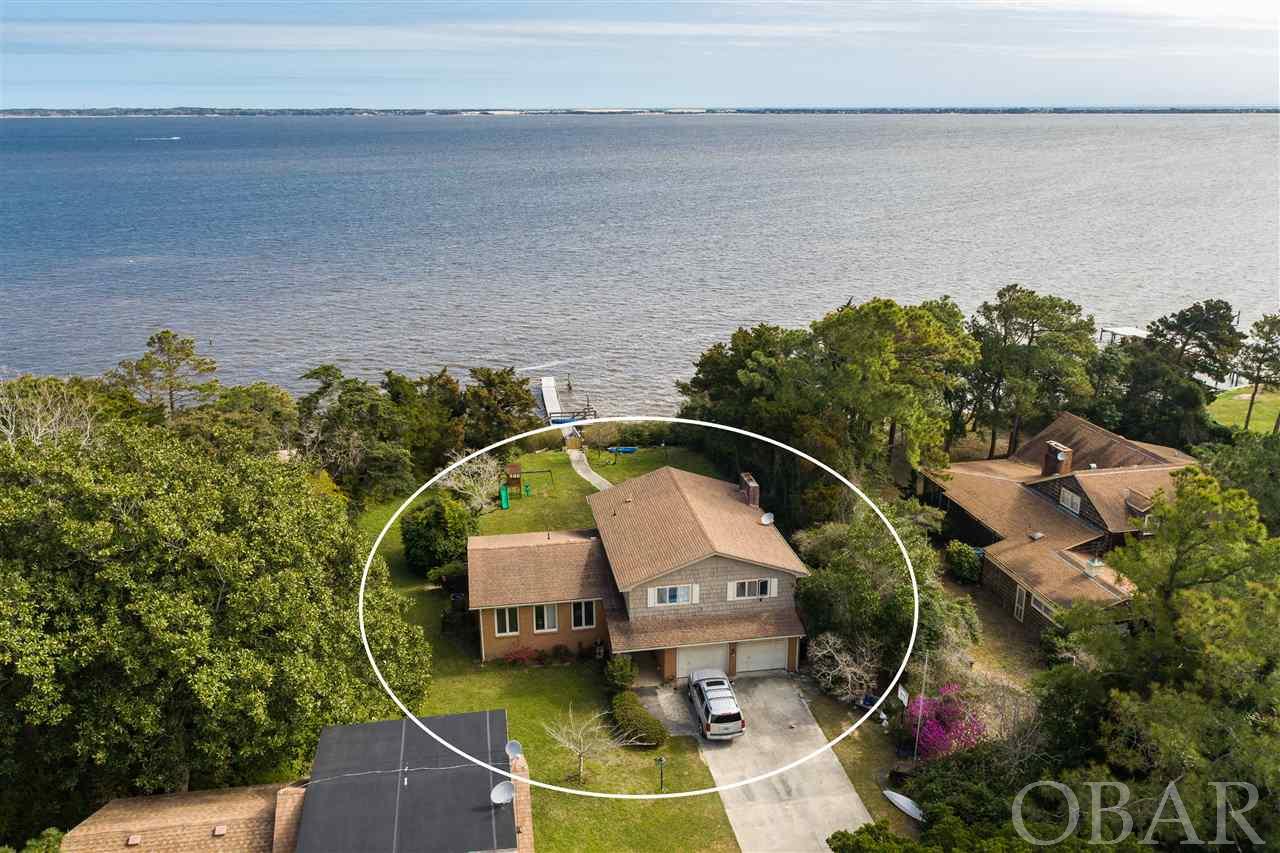 Incredible location in the heart of Manteo.  This .95 acre waterfront lot includes three rental units and a soundfront home which is also rented.  Located in an X flood zone, this waterfront parcel offers endless possibilities and great rental income to an investor or potential homebuyer.   Please use showing time.  Per owner, there are two septic tanks- one services main house and other services the rental unit. Contact listing agent for lease information and tenancy dates. 24 hrs notice required for showing.