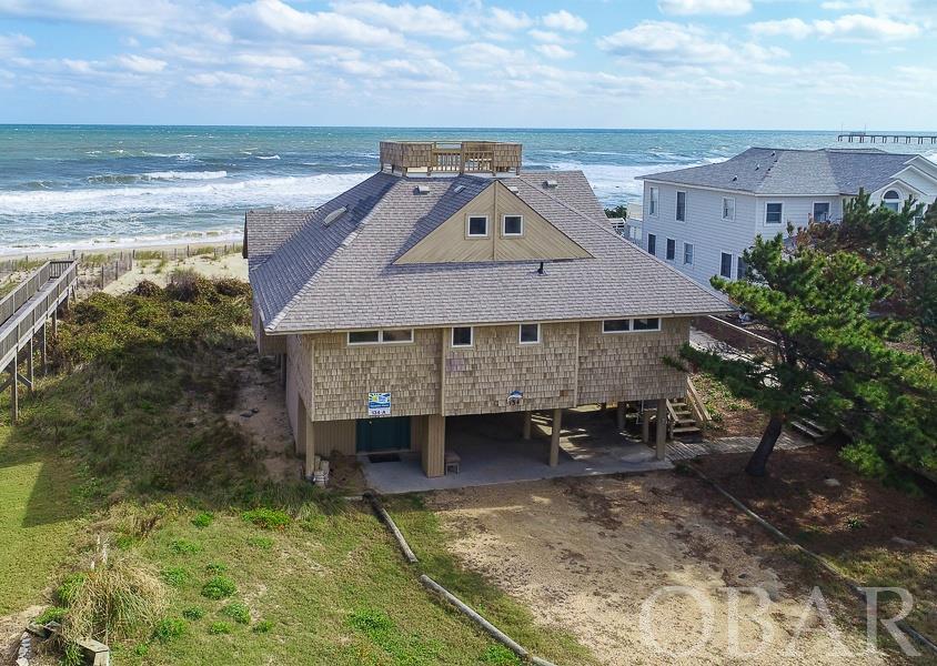 Very quaint oceanfront cottage in the heart of Duck.  Fishnet combines old world charm with present day upgrades. The home was originally built with extra long, round pilings sunk into the bedrock, so the foundation is strong. Inside, you will find a spacious living area with endless views of the ocean. New wood flooring on this level brings a fresh look to this lovely cottage. The ample kitchen has all the needed appliances and storage to make your guests comfortable. There are 3 bedrooms on this level including a king bedroom and pyramid bunk-room.  Upstairs is a master en-suite with tiled shower and custom (and separate) vanities. This private space also includes an East facing patio to enjoy a morning coffee or watch the dolphin play in the waves. A secret hatch leads to the roof top crows nest, offering some of the best views on the Atlantic seaboard.  The exterior of the house has just been repainted and new stairs have been added.  The Snow Geese South subdivision consists of just one road, so the beaches are never overpopulated. The subdivision also offers Sound access for crabbing of kayaking. From an investment standpoint, this property generates a strong GRY, bringing in over $100,000/yr. So, sit back in the hot tub and soak your cares away. As they say, the proof is in the pudding...here is what a recent guest had to say:   "Finding this home was like discovering that rare diamond. Ocean-front cottages that are cozy and perfect for one family (and their furry kids) are hard to come by! Our family has now stayed at Fishnet for 2 consecutive years and we will return! It's so well cared-for and comfortable, it feels like home instead of a rental property. With white-washed shiplap walls, whimsical mid-century furniture, this home has sophisticated, seaside charm. Climb the ladder to the rooftop Widow's Walk and enjoy panoramic views of the ocean and the sound for an added treat at sunrise or sunset! The recent beach nourishment has fortified the dunes with lots of soft white sand literally one step from Fishnet as the beach access is right next to the home, with no steep stairs to climb from beach to boardwalk. We were so sad to leave and can't wait to go back!"