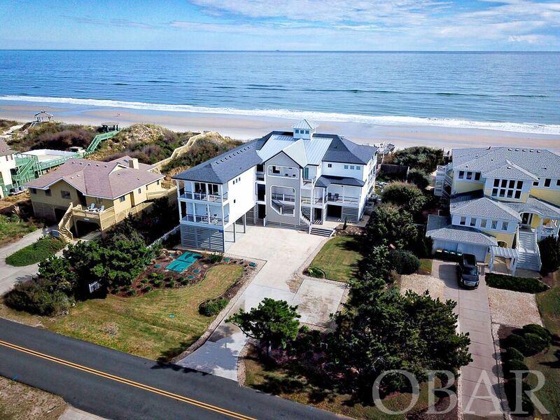 Fantastic Advertised Income 2021: $425,034.00 / w Owner Weeks Added $444,065. See Interactive 3D Virtual Tour Link. "Summer Moon"….Simply Dazzling….Created to Inspire You…..Made to Enhance You. Being on the Ocean at Summer Moon, gives You Nature’s Oceanfront Beauty at it’s Best.  Glorious amounts of glass windows provide a multitude of Ocean Views, capturing a transcendence quality, with the splashing surf dancing before you.  The inviting flow of this Oceanfront Beach Home embraces you with excitement, as the Top Level Entertainment Arena, is like Command Central for FUN !  Cascading Copula Chandelier swirls sparkles as an elegant essence radiates from the magnificent Ocean Views.   The Top Level boasts of these Entertainment Arenas: Incredible unobstructed Ocean Views !  The Living Area with an easy light Fireplace, creating a warm glow. Majestic Dining Table for Twenty with grand Ocean Views. Huge adjacent Kitchen convenient to all the action. A Wet Bar with Wine Cooler, Ice Maker, and cabinetry of glassware to choose from, for your libation to be refreshing and immediate.  A separate private Recreation Room, also with Ocean Views. And Four Master Bedroom Suites. As the Ocean Waves are splashing on shore of the wide Beautiful Beach of Corolla, you see and hear the Ocean from all angles. Two Oceanfront Decks are also immediately adjacent to the Great Room, to open for the Ocean Breezes or to move outdoors. Just seconds from the Great Room activities, You have access to the private Top Level Recreation Room with Billiards & Foosball, Video Games, More Flat Screen TVs, another Kitchenette; all of which is so easy to keep up with all the action in these multiple festive locations. Of the Twelve Master Bedrooms, Four are on the Top Level, and Eight are Mid Level, many with Ocean Views too.  Of the 12 Bedrooms, ALL 10 Adult Master Suite Bedrooms benefit from Private Bathrooms with beautifully Tiled Showers; plus Access to Outdoor Decking.  Then Two Bedrooms with Bunks are also Master Suites. Convenience of the Elevator makes Life Easy.  Then, tucked away also on the Mid Level, is the separate Theater Room / Bridal Suite to enjoy movies or the big game ! Outdoors there are even more additional Decks and Lounge Chairs at the Top Level, Mid Level, Dune Top, Poolside, and around the outdoor Fire Pit, too.  At Poolside, the Pool Fountains, Wet Bar with Two Full Size Refrigerators, Large Flat Screen TV and an abundance of Cushioned Sofas, lets the party continuously flow from the Top Level to the Poolside Level. Summer Moon’s uniquely special design flow, does wonders at maximizing Ocean Views from so many Living Areas, Bedrooms, Decks & Dunes ! Day or Evening, Summer Moon is a paradise setting, with expansive Ocean Views that are a rich vibrant hue, with surf pulsating with a passionate vigor, onto a glistening sand beach, to stroll along for miles…all of which makes this shorefront Beach Home as “One to Cherish”.  The Top of the Dune Deck and Lounge Area, is perfect to enjoy refreshments and to be revitalized by the tropical ocean breeze.  Various outdoor seating and decking provides a multitude of perspectives to enjoy the ocean essence.  All separate, yet close, to easily re-engage in all the action. The Pool offers many ways to enjoy the water with a shallow pool section; to the in-pool seating;  fountains cascading as waterfalls, and a deep water section for total immersion. In addition and adjacent to the Great Room and Dining Area is the huge Kitchen, with Dual Refrigerators, Dual Sinks and Counters, Dual Ovens, Dual Dishwashers; Microwave and Six Burner Instant Heat Gas Stove;  GE High Caliber Appliances….even the Kitchen gets the splendor of more Ocean Views. Summer Moon’s  quality is ideal for Weddings, Family Re-Unions, Conventions, and Loved Ones.  Luxury Furnishings abound, beckoning you to relax. Summer Moon’s fantastic design makes it so delightful to just become part of the Ocean’s magnificence… enriching your soul.