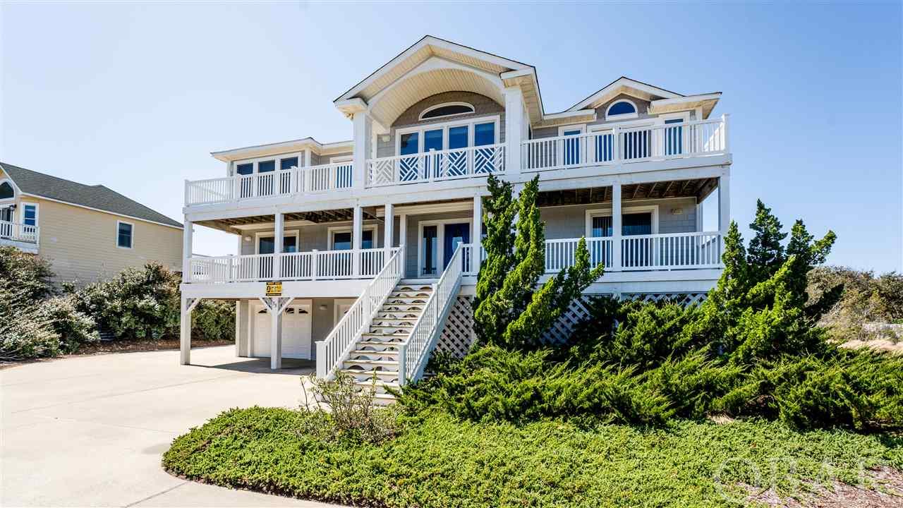 If you have been waiting for a gorgeous, turn-key, meticulously maintained beach home with ocean views, you’ve just found it! Located one lot off the ocean in Southern Shores, Barefoot Key has everything you’d ever want or need in a beach home. Seven spacious bedrooms (six of them with private baths), huge living, kitchen, & dining areas, elevator, mid level den, ground floor game room with full fridge, top floor sun room, very private pool area with open space behind, two large garages, and so much more! Enjoy the beautiful ocean views from the huge top floor great room where there is plenty of seating for large groups. Entertain while you cook in the beautifully updated kitchen with quartz countertops, tile floor, stainless steel appliances (Whirlpool & Samsung), tile backsplash, two dishwashers, bar top seating, and a pantry. Large master suite on top floor with deck access, private bath with tiled floor, jet tub, & glass/tile shower. There is a huge owner lockup closet located in the top floor master so you can store everything you need for your visits to the beach. Tastefully furnished throughout with a bright & beachy theme. Read a book or just relax in the sun room overlooking the pool & huge backyard with so much privacy! Back sun deck has built in benches perfect for some sunset cocktails. And the gas fireplace is ideal for those cool OBX evenings. Powder room located on top floor. Enjoy your morning coffee on the sun decks while watching the sunrise over ocean. Large mid level living were with lots of seating & large TV so everyone can spread out to watch their favorite shows. Five spacious bedrooms on mid level, three with deck access. Enjoy a game of pool in the ground floor game room while watching your favorite sports. Large master on ground floor & a half bath as well. Grab a snack or drink from the game room fridge & head out to the pool (approx 33x15) where you can soak up the sun in large deck area perfect for lounging & take a dip in the hot tub too. Nice outdoor showers by pool area. Ideal location near the beach access & super close to the great nearby shops & restaurants. You can even walk or bike into the Village of Duck on the multi use path. Southern Shores offers private beach accesses, sound access with a beach & picnic area, tennis courts & even a boat launch/marina. These original owners have taken excellent care of this stunning home so you won’t need to lift a finger! Extensive list of upgrades & improvements in associated docs. Top quality windows & sliders, which allow for amazing natural lighting. Top floor windows all have a sun protective tint to help cool & limit fading. Oversized lot which backs to open space for extra privacy. The owners limit rentals on this property so no wear & tear! Exterior is also in pristine condition with low maintenance, vinyl shakes & vinyl handrails, and gutters. Nicely landscaped with lots of vegetation for privacy & a basketball hoop in driveway. High quality new roof in 2019. Projection on file shows the potential to maximize rents & this home also has the potential to add bedrooms on ground floor to add even more income. Two spacious garages, (900 sq ft)one used as a Private “owner garage” with an extra storage area. Plenty of parking too. You wouldn’t believe how well this home has been lovingly maintained. Looks brand new! This is the one you’ve been waiting for! X flood zone and no flood insurance required.Be sure to view the virtual tour of this amazing property by clicking the link or cut/paste into your browser: https://my.matterport.com/show/?m=UWWDgKNdASm&mls=1