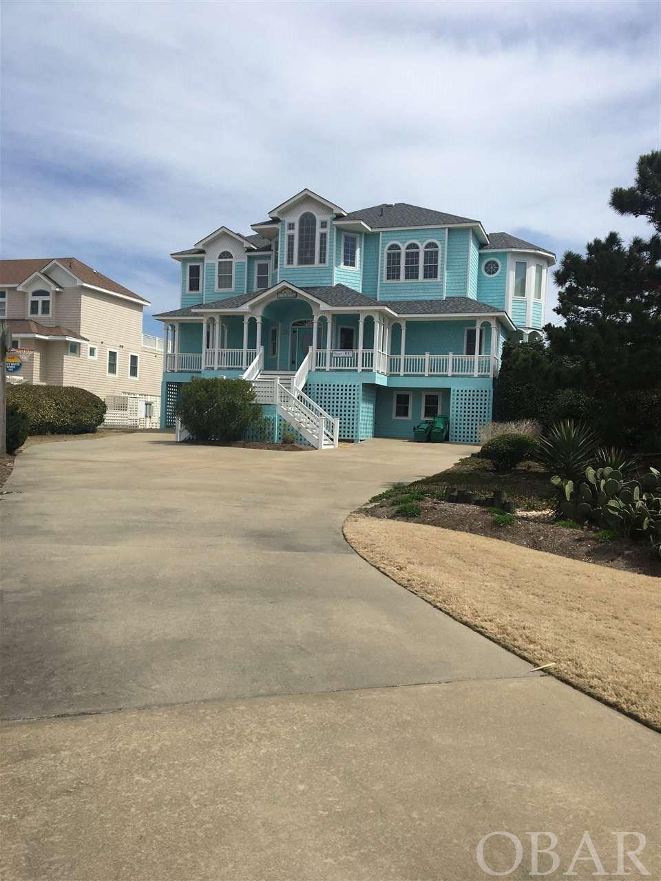 If you are looking for a bright open oceanfront house with a solid double dune line and huge pool area OB Xtasy is for you.  As you enter the house on the mid floor you will be impressed with the curved wood staircase that leads to the upper level.  The great room features a fireplace, wetbar with an icemaker and custom built in cabinets.   The gourmet kitchen has double ovens, gas cooktop, double dishwashers that were replaced in 2021 and a large island.  The south facing tower area holds the breakfast nook with windows on 3 sides. There is a large master bedroom with a huge walk in closet  master bath with ceramic shower and jacuzzi tub.  Overlooking the living area is a loft for reading or just watching the waves. The mid level has 5 master bedrooms and numerous owner locked closets.The ground floor has a game room  with custom built in cabinets a bunk bedroom, bathroom , separate pool table room, laundry area and a garage. Double outside showers and fun tiki bar lead to the large pool area.  This house has plenty of room to spread out and enjoy life at the OBX. Owners only rent late May till the end of October.