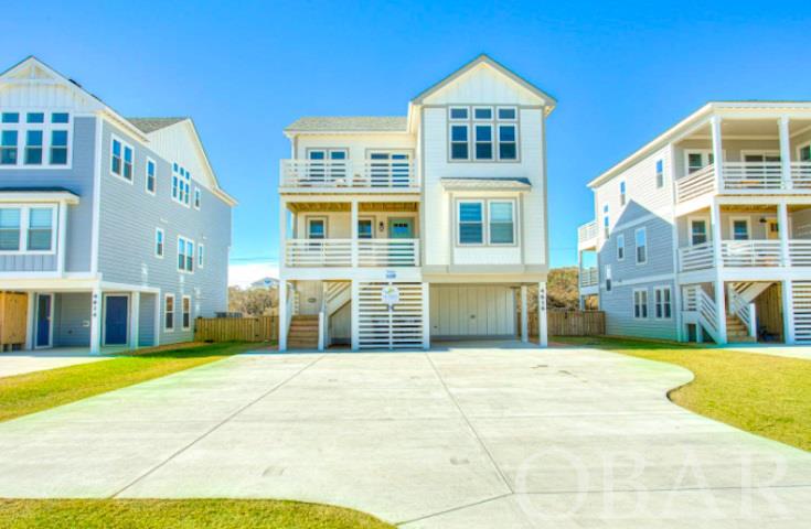 Excellent location and rental income! This 6 bedrooms and 6.5 baths home located in the heart of Kitty Hawk has everything you need for a perfect vacation! Plenty of space, huge chefs kitchen, game room, in ground custom concrete pool and is just steps from the beach! Take in the ocean views from the kitchen, living room and top deck. The kitchen is complete with stunning quartz countertops, dove tail cabinets, and stainless steel appliances. The first floor has a game room with pool table, second refrigerator and dishwasher for extra entertaining as well as a second living room with a pull out sofa. Additional features include an elevator, tankless water heater, and irrigation system. This home comes fully furnished. Each room is styled with a coastal flare and includes flat screen smart TVs. The outside area is built for entertaining! Complete with an outdoor bar, in-ground custom concrete pool, hot tub and the special fenced in event space. This home is one of 3 that can be rented for private events. The 150' x 125' lawn space behind the home is fully fenced in with a service entrance to the north and fully equip with outdoor electric for lights and sound. This is the perfect space for weddings, family reunions etc.