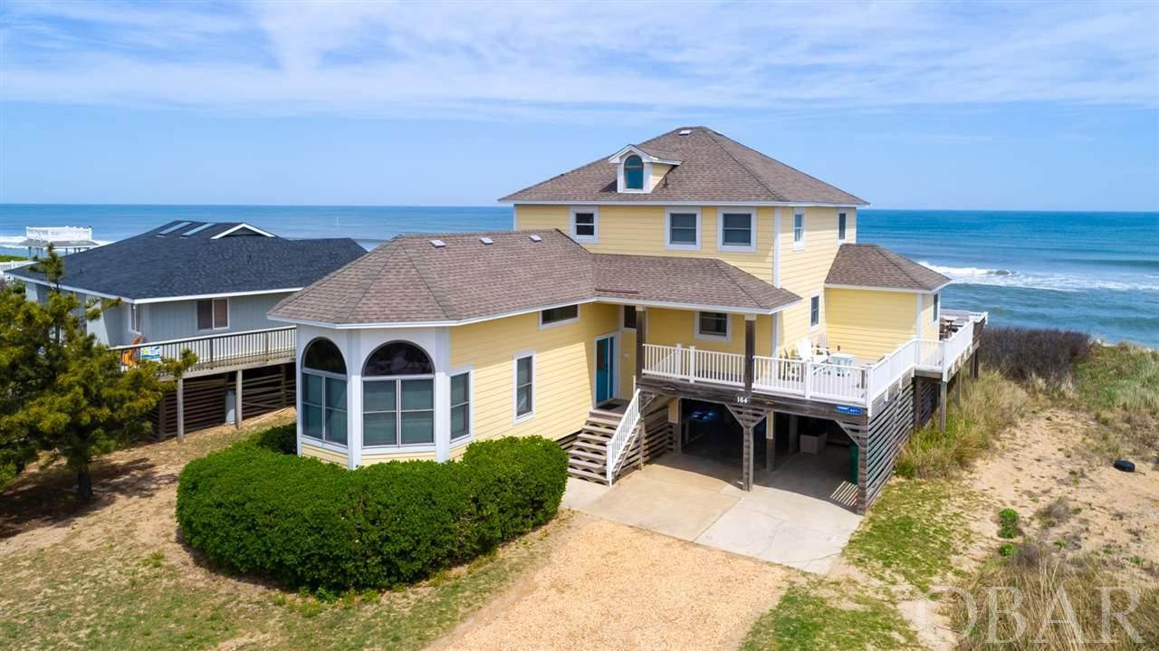 Meticulously maintained oceanfront in the heart of Duck Village! Over $120K in rental income with owners taking 4 weeks for themselves. Potential to do more than $130K/year. Owners have kept the home in great shape, with many recent improvements! NEW ROOF IN 2021, ALL new HVACs in the last 3 years, new outdoor entertainment area under the house and pool table, new beds, new smart TVs, all new LVT flooring, new siding, paint, charging station for electric cars, and new outdoor furniture, to name a few. Kitchen was remodeled in 2016 with new appliances and granite counters. Enjoy ocean views from all levels, spacious bedrooms, and beautiful furnishings.