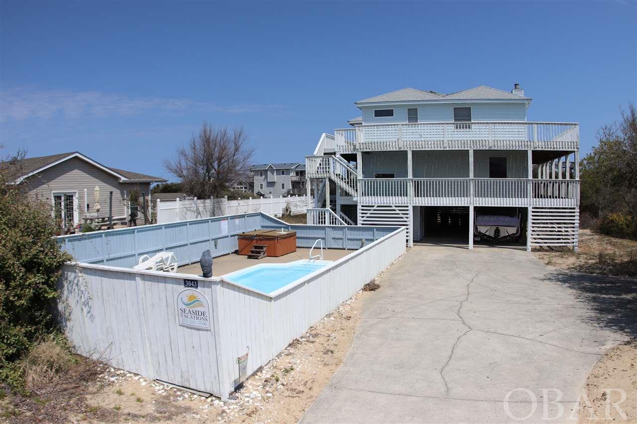 This classic OBX vacation rental home is set up for easy beach living. You have good ocean views from the kitchen, living rooms screened porch and sun decks. With over 1000 square feet of sun deck and over 500 square feet of covered deck outside living is easy and comfortable. Each bedroom is larger than most similar type homes and a master bedroom can easily be created by blocking off the bathroom door to the bunk room.  There's a deeded easement across neighbor's property so once you arrive you don't have to get near Duck Road again. This Southern Shores location gives you quiet beaches and quick access off the island. Owner blocks off all but 7 weeks each summer so rental income could easily be increased.  Ask your Realtor for the projection.