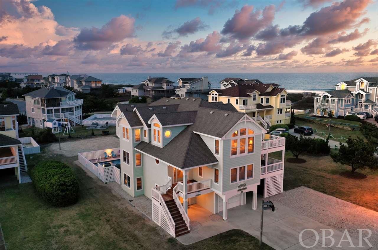 This is the one you have been waiting for located in the heart of Duck and the coveted exclusive community of Duck Landing! A rare opportunity to own an 8 bedroom semi-oceanfront home with 7 full baths, 3 half baths, an elevator, theater room, saltwater heated pool and just steps from the beach access and community amenities. Enjoy the indoor pool, clubhouse with fitness center, and outdoor tennis court right across the street. The home boasts a wonderful handicap friendly floor plan - the elevator ascends from the ground floor to the large great room (top level) with 2 gathering areas, cathedral ceiling, gas fireplace, a chef's kitchen, formal dining room, breakfast area all with expansive ocean views. The spacious and beautifully crafted kitchen offers granite countertops, large center island, 2 dishwashers, 2 smooth top range/ovens, 2 microwaves, ice maker, prep sink, wine cooler, and plenty of seating for everyone. This floor also offers a powder bath, and a large master suite with a large ensuite bath that includes a his and her vanity, separate shower, a whirlpool tub for two and a private ocean view balcony. You'll love the ample sized sun deck perfectly situated to take advantage of those gorgeous ocean views, or to watch a full moon glistening over the ocean at night. The mid-level offers 5 bedrooms, 3 are master suites, and all but one, have their own private deck access. This level has a huge theater room that everyone loves on rainy days, or watching a movie with the family at night. The ground level has 2 bedrooms, one master suite, a full bath and a game room with a full-size refrigerator. The fun continues outside by the pool, hot tub, or the volley ball area. Take advantage of the over-sized one car garage that's currently used as storage, or add a ping pong table and make another amenity for your guests. Recent improvements include; top floor HVAC installed 2020, 2nd floor installed approx. 2017, hot water heater 2020, and the entire pool area renovated in 2019 with Cool Deck, new coping, and an EcoFinish coating. The rental potential can definitely be maximized by opening the entire calendar year, however the seller limits rentals from June to September. Duck Landing is conveniently located to the new town park and mile long soundfront boardwalk, renowned OBX restaurants, boutiques, Village Yoga, water sports, and more! ****Call Agent for More Details.****