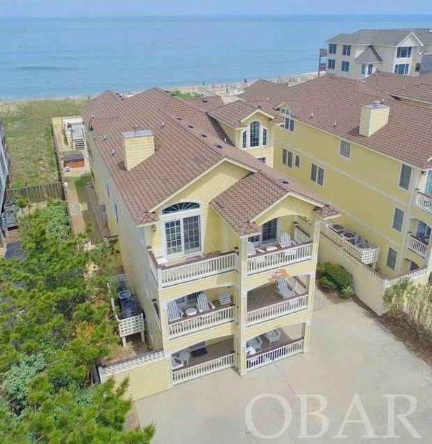 10 BR 10.5 baths  OCEANFRONT Luxury Property on  "Millionaire's Row" in heart of  Kill Devil Hills! Over  $308,0000 in  rent for 2021! Projections for 2022 Over $315,000.  Recently updated kitchen with quartz and ss appliances. This fabulous 10 bedroom 10.5 bath Custom Oceanfront Estate features superb craftsmanship from one of Outer Banks most prestigious well known builders East Coast Construction. This home has beautiful designer furnishings throughout and has  elevator and separate theater room.  Dining room to seat 20, and  Large Open Dining and  Living Room overlooking Atlantic Ocean, Extra Large Master with  Sitting and Huge Smart Tv, The Ground level features a Theater Room with extra large screen. Sports Bar/Rec Room includes kitchenette, billiard Table, game table, foosball, arcade , ping pong  and multiple TV’s. The grand outside living area features  a pool House/cabana  equipped with a wet bar, refrigerator, full bath, rooftop sundeck, heated pool and hot tub. Solid rental history and top rated by guests!