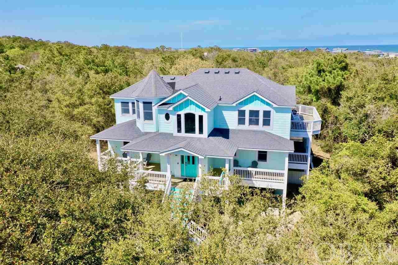 An opportunity to own this close to the beach in Chicahauk rarely comes along! Closer to the ocean than many oceanside homes, you'll love the quick trip to the lifeguarded beach access! 6 bedrooms with 4 full baths and 2 half baths in one of the most coveted communities on the Outer Banks. Situated in an X Flood Zone on a huge 27,000+ square foot lot. Expansion opportunities and the peaceful privacy is priceless! Currently the property is utilized as an investment rental but would also function well as a year-round home with loads of extra storage spaces. The home boasts a wonderful spacious floor-plan perfect for spreading out and entertaining with an abundance of natural light and bedrooms on all 3 levels including 3 Master Suites. Spacious open Kitchen, Dining & Great rooms with gas fireplace lend access to a sun deck & loft with Bar. Large 16x33 Private Pool with Toddler Wading Pool, Hot Tub, Outdoor Shower & Basketball Court are ready for outdoor entertainment. Wired for Outdoor speakers. The lush Live Oaks lend privacy and a feeling of seclusion from neighbors. The Recreation Room currently features a Foosball table, TV center and sofas, but add a billiards table for additional fun! Ground floor offers a Master Bedroom Suite, plenty of extra closet storage, dry entry from garage & 1/2 bath which services the Game Room & Pool. Mid Level features 1 King Master Suite, 3 additional bedrooms, a hall bath, Laundry Closet and access to a nicely sized covered deck. The top level offers open concept living with spacious Kitchen, center island with counter seating, Dining & Great rooms with built-in cabinetry and access to a nice sun deck. A half bath services the Living area and quaint loft is available for a reading nook or additional entertaining space. A 3rd Master Bedroom is situated on this level with private bath and walk-in closet. Chicahauk features nature trails, bike and walking paths to your choice of nearby restaurants, shopping, specialty stores and more. Join the Southern Shores Civic Association and enjoy Soundside Marinas with boat launches, picnic/fishing/crabbing areas, Sound front Beach, additional Private Beach accesses, parks, basketball and soccer field. Schedule your tour today- it won't last long!!