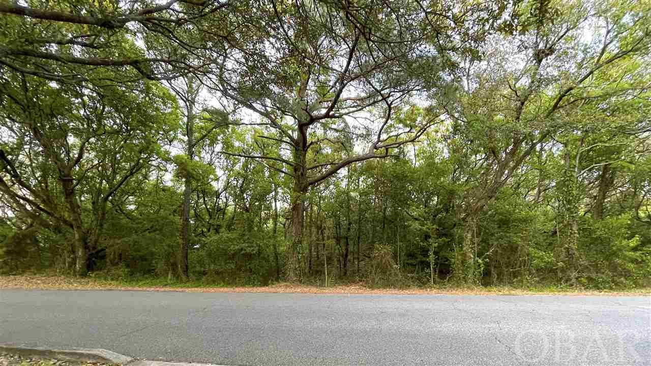 Great Location in coveted Chicahauk Subdivision - Town of Southern Shores.  136' adjacent to large parcel of Common Area that is owned by the HOA - No construction and No Back Yard Neighbors.  Almost half acre (.48), Depth 170 plus feet. You can leave all the gorgeous live oak trees you want when you start construction. Lot not yet cleared! Private, Quiet but close to the beach! Build Your Own Haven on the Coast of North Carolina.