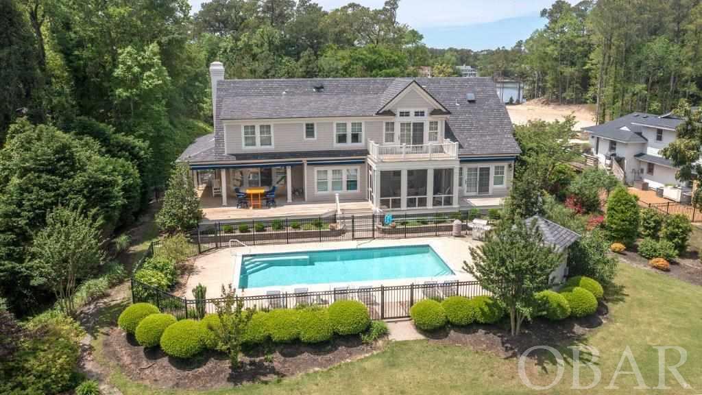 Absolutely Beautiful Custom Home in Southern Shores built by Glenn Wickre * High Elevation Lot "X" Flood Zone  * Located on a 28,000sf Deep Water Canal Homesite in a Protected Cove w/ Bulkhead & Boat Dock * Quick Boat access to Jean Guite Creek & the Currituck Sound * You will love the feel of this Home * The design and planning were meticulous in every detail * Upon entering you will immediately notice the quality and feel the warmth * You will be greeted with a stunning foyer w/ volume ceiling. Generous open but separate spaces for the Kitchen, Dining & Living spaces * The Custom Kitchen features high end appliances including a Wolf gas range/oven & recessed hood fan with built-in spice racks -- perfect for the chef in you * Over-sized SUB-ZERO * Rich granite counters - inset Kitchen sink with double window looking out into the 234sf Screened Porch & toward the Pool & Canal * 3 Tier Center Island is great for Prep & Entertaining - seats 4 plus * check out the fast foot pedal under the prep sink - it controls the faucet when  your hands are busy * You will enjoy lots of natural lighting from a perfectly designed window arrangement and generous use of light catching Transoms * Open Dining area w/ plenty of room for sizable table/seating * Custom Wet Bar counter w/ wine & champagne labels (very cool!) - Bar features wine cooler & Miele Built-in coffee maker - makes espresso & more * The living area Features Masonry Gas Fireplace w/ Brick Hearth - you can remove the chimney cap & enjoy a Wood Burning Fireplace * Generous built-ins, Shiplap & custom Crown Molding throughout * Brazilian Cherry Hardwood flooring * The Main Level Master Bedroom features access to Private Sun Deck * spacious Bath with large walk-in closet, Dual Vanities, Soaking Tub, Tiled Shower with Dual Controls & private water closet ... the Built-ins are Amazing! * Spacious pass through Laundry Space with Granite Counter w/ Ceramic Sink, door to front deck ... the west end of the laundry room is the hallway that leads to an exterior door & 3 Car Finished 912sf Garage - mechanicals include gas Rinnai Water Heater * Huge Finished space over garage -- great for Guest Suite features Full Bath - use as 5th BR * Level 2 Features Three additional Master Bedrooms - all with Gorgeous Baths * One Bedroom has Large Private Balcony Deck overlooking Pool, Yard & Water & through that room you can access an expansive floored Walk-in Attic - excellent storage space *** The Community of Southern Shores has a voluntary Civic Association at $65yr, and you can join the Boat Club for $25yr and Tennis $25yr * Boat slips additional * Boat Ramp included ... You will have access to multiple beach accesses - including the Hillcrest Beach Access w/ approximately 60 spaces, outside showers, dune gazebo & deck looking out over the Atlantic Ocean, volleyball court, and lifeguard in summer * 3 Boat Marinas, 2 Soundfront Beach/Parks - great for Sunsets w/ Wine & Cheese * New sidewalk along entire South & East Dogwood Trail to the Beach & along Duck Road - miles of biking/walking * Duck Shops and Restaurants just minutes way * Corolla Lighthouse, Wright Brothers Memorial, Jockeys Ridge & much more * Easy in-community roads to get to the Marketplace Shopping Center & Starbucks * Kitty Hawk Elementary School is just minutes away! Easy access out to the Wright Memorial Bridge * Great Community, Wonderful Neighbors * Landscaped / Irrigation * Alarm system in place * Southern Living Covered Porch * 3 Awnings for Morning Shade * Main Front Entry Door has Programmable Roll Down Screen for Evening Sun shade * The Design, Amenities, Finishes and Quality of this Home make this a One-of-a-Kind * Why Build? * Constructed in 2007 yet looks New *  Imagine how much you will enjoy coming home ... Fun in your Heated Saltwater Pool ... Carolina Sunsets on the Sound in your boat & back to your dock in minutes * Home Offered mostly Furnished w/ exclusions * You will absolutely love it in every way! Come see ...
