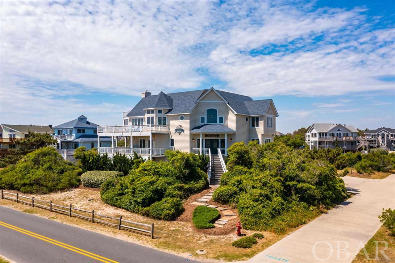 Here's what you've been looking for! A gorgeous, updated beach house in Whalehead, Corolla with AMAZING VIEWS and a direct beach access! Add in the stunning chandelier you see when you enter the 2-story foyer and the beautiful staircase with iron balusters. That custom kitchen and those fabulous bathrooms with custom tile and cabinetry are to die for. Relax in the spacious and very functional top floor great room, slip off to the mid-level den to watch a movie or catch a quick nap, or venture down to the enormous recreational room for shooting pool, playing foosball and watching TV. The sundecks and covered decks don't disappoint with breathtaking views of the ocean, soothing sounds of the shore break and the sweet smell of the sea. Enjoy swimming in your own large and heated outdoor pool with plenty of deck space for sunbathing. Take a break from the sun at the tiki bar, or hit the volleyball court for more outdoor fun! Don't forget that hot tub to enjoy under the stars or anytime is perfectly fine. This home offers the rare opportunity to get up early, grab your coffee and watch the sunrise right from your very own, peaceful deck. This home has been lovingly cared for, and it shows! It is in pristine condition. Stop dreaming! Now you can hear the waves, see the blue ocean, smell the salt air, and marvel at the sunrise painted sky from your own Corolla beach house!