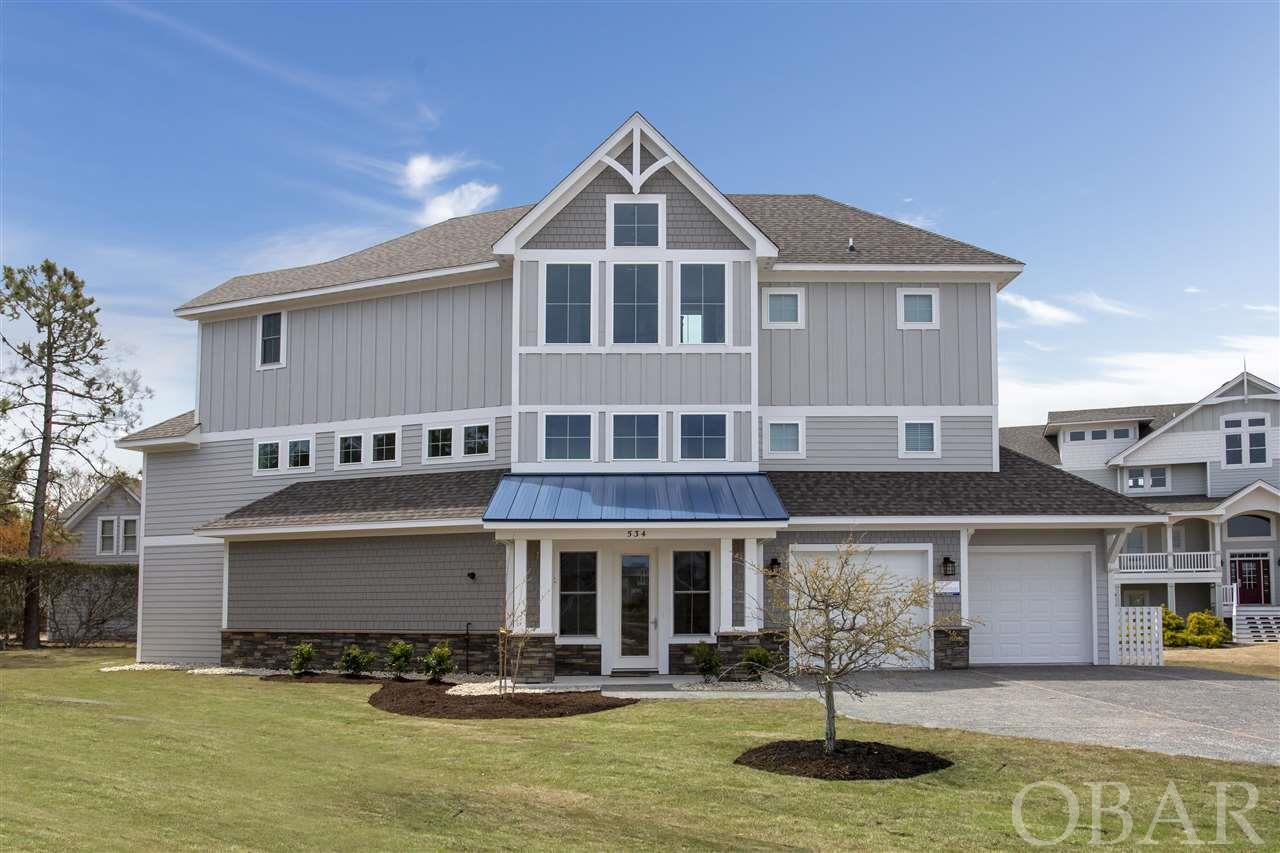 Have you been searching for your OBX Dream Home that leaves no box unchecked? Search no more...you've found it! This Currituck Club beauty has everything you could possibly want and more! Located in beautiful Seaside Corolla NC, this 6 bedroom, 6.5 bath charmer is simply exquisite. 4 roomy master bedrooms. Huge ground level entertainment room, elevator, garage game room that opens up to the pool / bar area. Built in bunk beds, Gourmet Kitchen with Huge Quartz Countertop. The epitome of understated attention to detail. "Summer Love" features beautiful views of the Currituck Sound and promises to deliver many gorgeous sunsets. Professionally Decorated, Why build when you have it all right here.