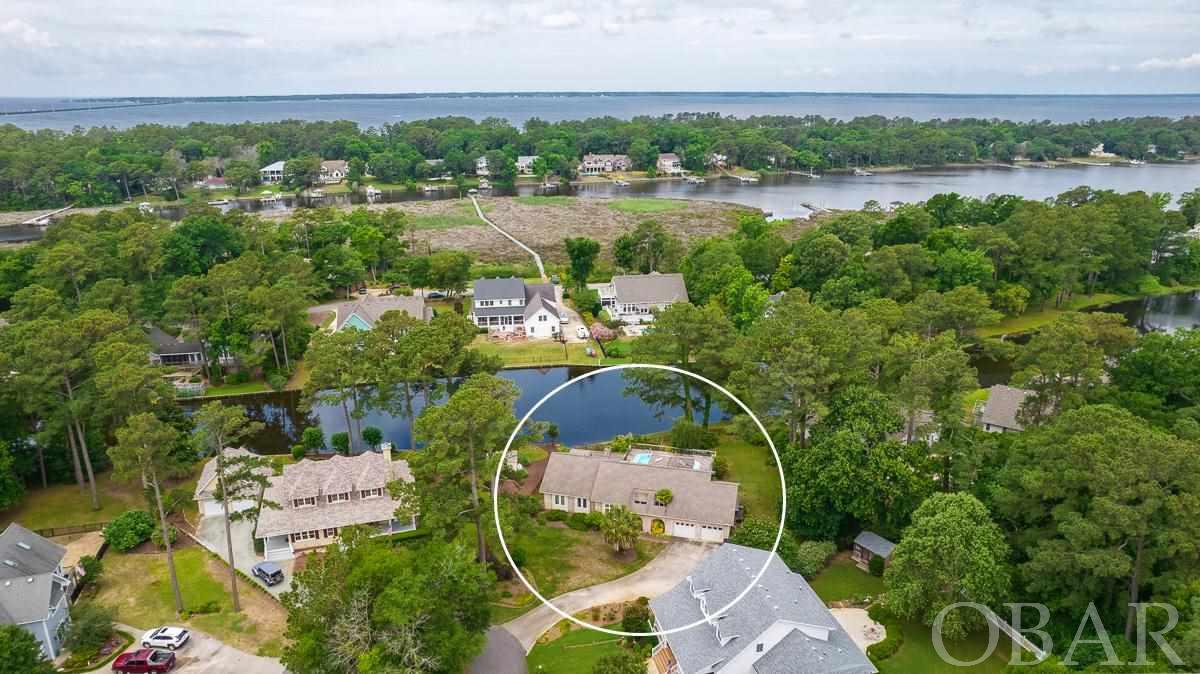 One level, three bedroom, two bathroom, beautiful brick home located in Southern Shores. Pond front, private pool, office, sun deck, screen porch, large open living and kitchen area. Master bedroom has access to private deck with pool. Cathedral ceiling with sky lights in main living area.