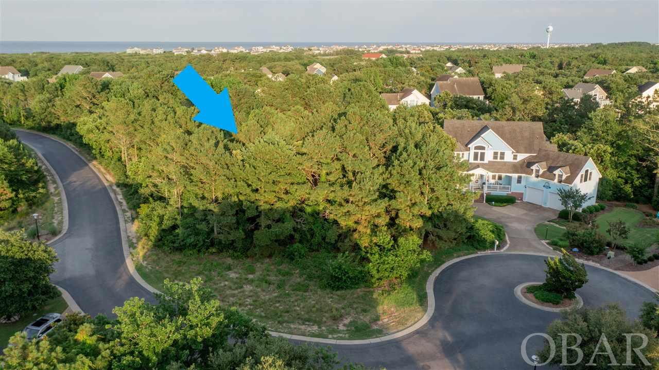Fantastic building site in popular Currituck Club subdivision! Located just one lot off the sound on a quiet street, this will be an ideal spot for your new dream home! Enjoy the amazing OBX sunsets over the sound and walk or bike to nearby shops and restaurants. The Currituck Club has a great amenity package with community pools, tennis, playground, clubhouse and more! There's even a convenient trolley that can take you all around and over to the beach access to enjoy the beautiful beaches of Corolla. Still looking for that perfect beach house? Might be time to build your ideal custom home!