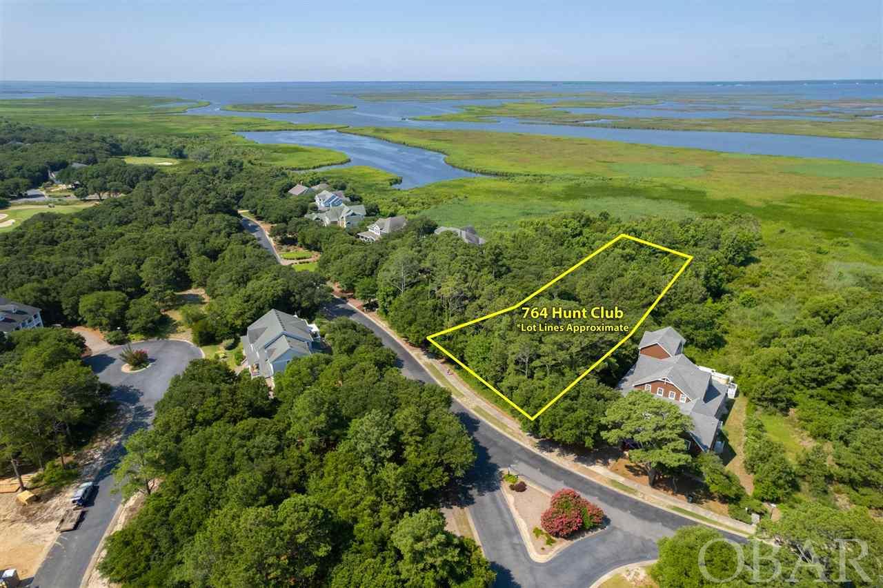 Large, sound front lot available for building your OBX dream home.  This wooded site is over 300’ deep with proposed views of the Albemarle Sound, rich with abundant waterfowl, and endless sunsets.  Build a custom home on this private homesite located at the northern end of The Currituck Club and enjoy the many amenities offered in this renowned, gated golf course community. The Currituck Club boasts several community pools, a fitness center, tennis, basketball and volleyball, in-season concierge services, trolley shuttles, and an 18-hole Reese Jones designed world-class golf course, along with a Clubhouse, restaurant, and pro-shop.   Now is the time to start making your Outer Banks dream come true with a sound front homesite in one of the most desirable OBX communities!