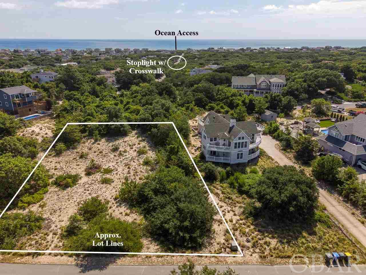 This Primo lot at 51 N Dune Loop is located in a neighborhood so coveted by property owners that homes and land rarely change hands. Without question the best non waterfront lot on the market currently in the Northern Beaches. This lot is one of the highest elevations on the entire Outer Banks at 46 feet above sea level and climbing !! Enjoy panoramic sound views and sweeping ocean views on the horizon from your home on top of the hill. Rest easy and Never worry about flooding here. Super Fun and friendly neighbors along with quiet roads make this a solid place to call home. An easy walk to the ocean access via Sea Oats Trail, with stoplight to safely cross Duck Road. HOA fee is voluntary, but is only $65 for primary/second home owners and $95 for rental homes. Boat Club and/or Tennis Club annual dues are $25 each.