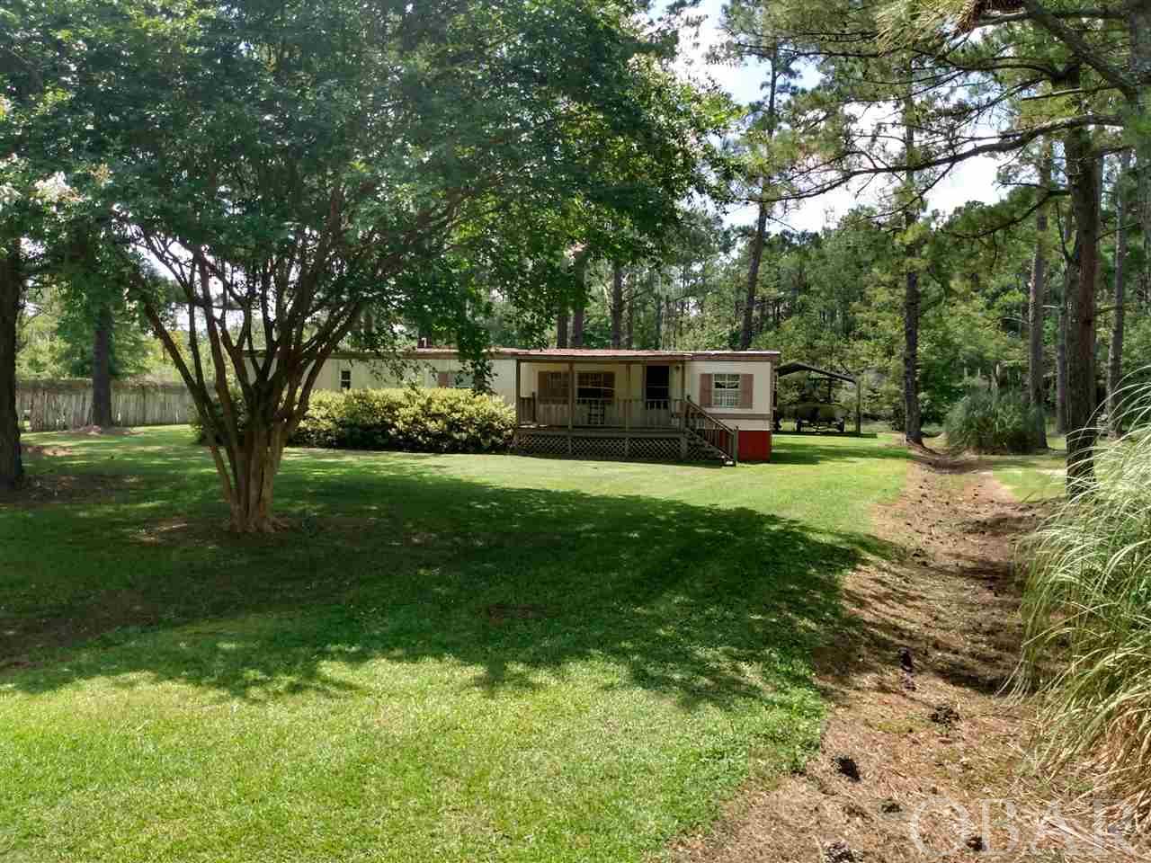 Nice mobile home on a spacious partially wooded lot. Set- up and ready to move in with appliances and furniture conveying. Large 20' X 27' detached metal shed idea for storing vehicles, boats, jet skis, lawn and garden equipment and supplies. Great property for a weekend stay or a stopping destination before the beach! Excellent place to take advantage of the abundant marine and wildlife resources in Tyrrell County, N.C. Priced to Sell! Cash offers only.