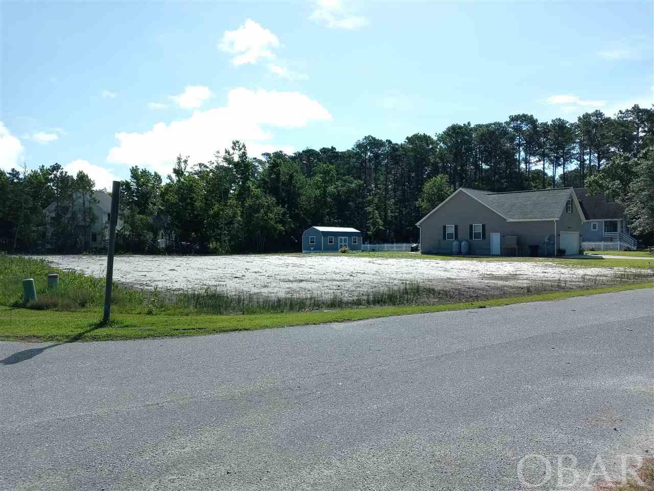 This X Flood zone lot is located in a small, serene, and beautiful neighborhood. Close to shopping and Manteo waterfront. This lot has recently been cleared and the water tap has been paid for by the sellers, it is ready to build your dream home.  Restrictive covenants do require a minimum of 1200 heated square footage. Drive by today and see for yourself how great it really is.