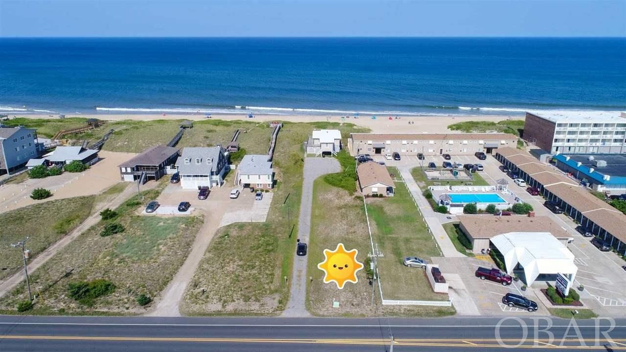 Don't wait! Centrally located in Kill Devil Hills. The only oceanfront lot available from S.Nags Head to Corolla. Close to many restaurants, Wright Brothers Memorial and Airport, shopping.... Sold for lot value only. The 1954 house is not warranted. This is a deep lot with a high elevation on the east side and wide, vegetated dune. The flood zone is X on the street half and VE on ocean side. Building possibilities may vary. See documents for zoning, setbacks, and a location survey.    Brokers, please see Notes and documents.