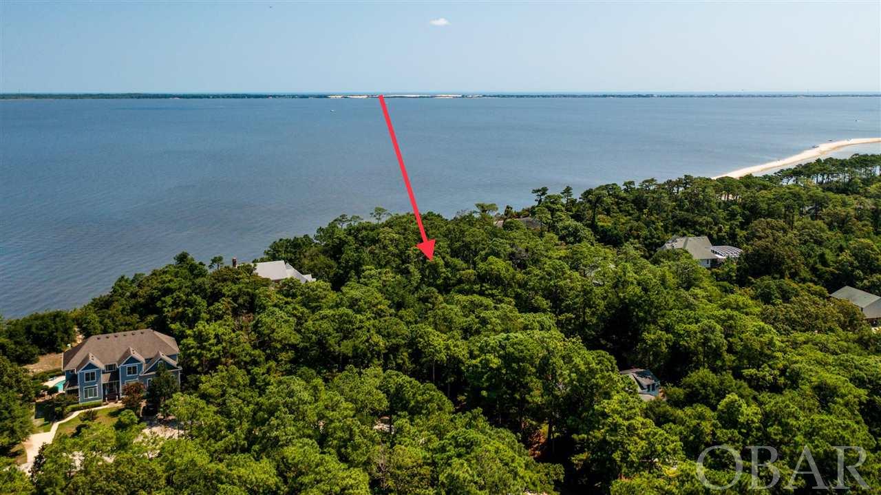 Rare and stunning soundfront building site on Roanoke Island with 1.9 acres of pristine Mid-Atlantic Maritime Forest and 215' of frontage on Roanoke Sound. This huge wooded tranquil building site will accommodate a grand home, private pool and a compound built high above the water and afford incredible views. There is nothing like having a private soundfront beach in your front yard. If you are looking for privacy and placidity in an upscale neighborhood, this is it. These wooded hills are rich in history and a short bike ride north on the paved path will take you to Fort Raleigh, The Lost Colony and Elizabethan Gardens. Ride your bicycle south along the trail to the beautiful Manteo Waterfront with wonderful restaurants, shops and galleries. This is a once in a lifetime opportunity to live in one of the most beautiful and serene areas on the Outer Banks.
