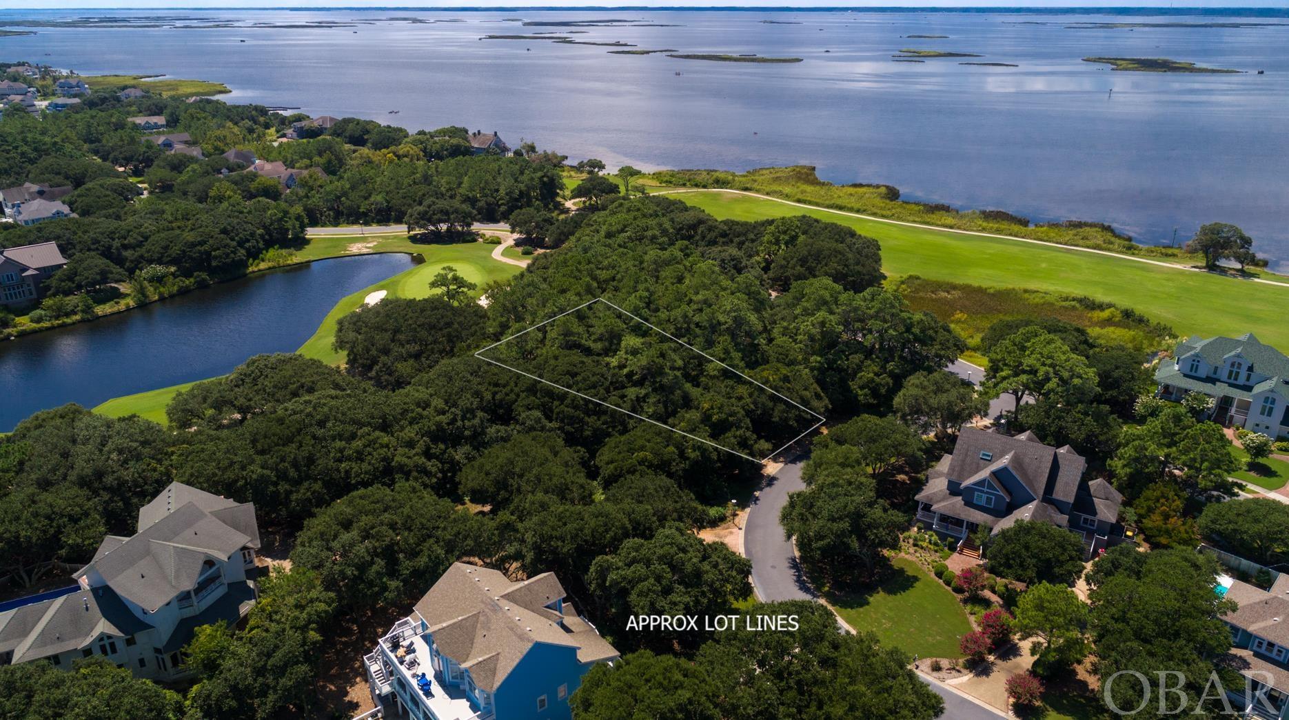 Beautiful homesite overlooking the 6th hole of the Currituck Club Golf Course with potential sound views. Build your dream home in this prestigious gated community of Corolla! The lot backs up to the 6th hole, so that you'd enjoy golf and water views on the south side of the home. Enjoy all the amenities that the Currituck Club has to offer-- including private beach access with valet trolley service, a Rees Jones designed 18 hole golf course with driving range, pro shop, and Bistro. Multiple community pools, tennis courts, and a fitness and health center make this community ideal for full time ownership or provide great options for a guests looking for an idyllic rental. Well appointed and located minutes away from shopping and dining in Corolla. The historical Whalehead Park, Corolla Lighthouse, and the 4-wheel drive beaches are just minutes away!
