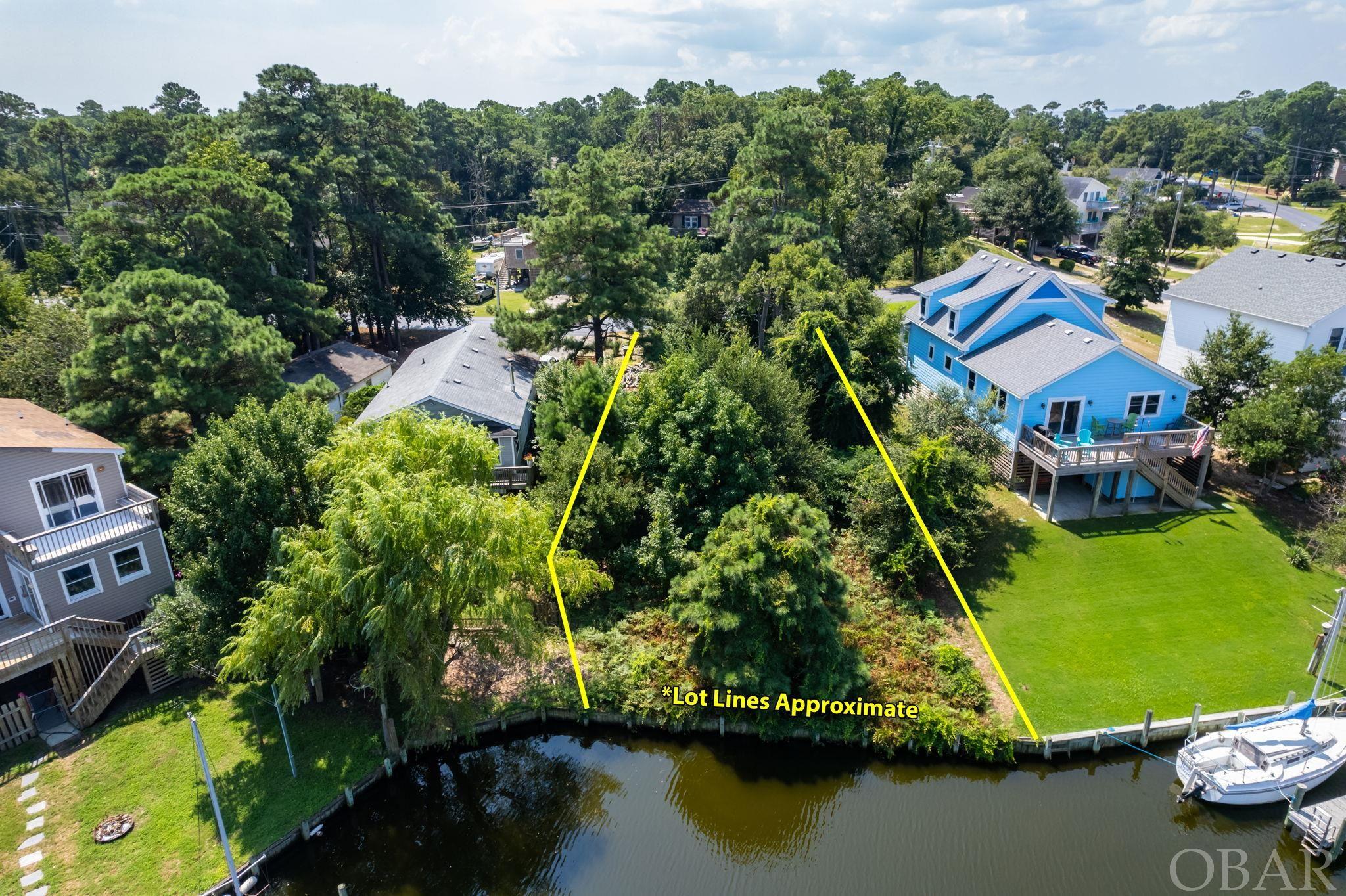Canal front lot available for a custom-built home in the gated community of Colington Harbor.  Perfect for the boating enthusiast, this bulkheaded lot sits on one of the many deep and wide canals in this predominantly year-round island community.  The Harbor features fantastic boating access to the wide-open waters of the Albemarle Sound and is just 10 miles from the Intercoastal Waterway.   Enjoy the marina, sound side park, club house, or swim and tennis club among the many community amenities offered.  Located just far enough away from the daily hustle, yet convenient to the local restaurants, shopping and attractions of Kill Devil Hills and surrounding areas, this tranquil homesite will provide the opportunity for true waterfront living.