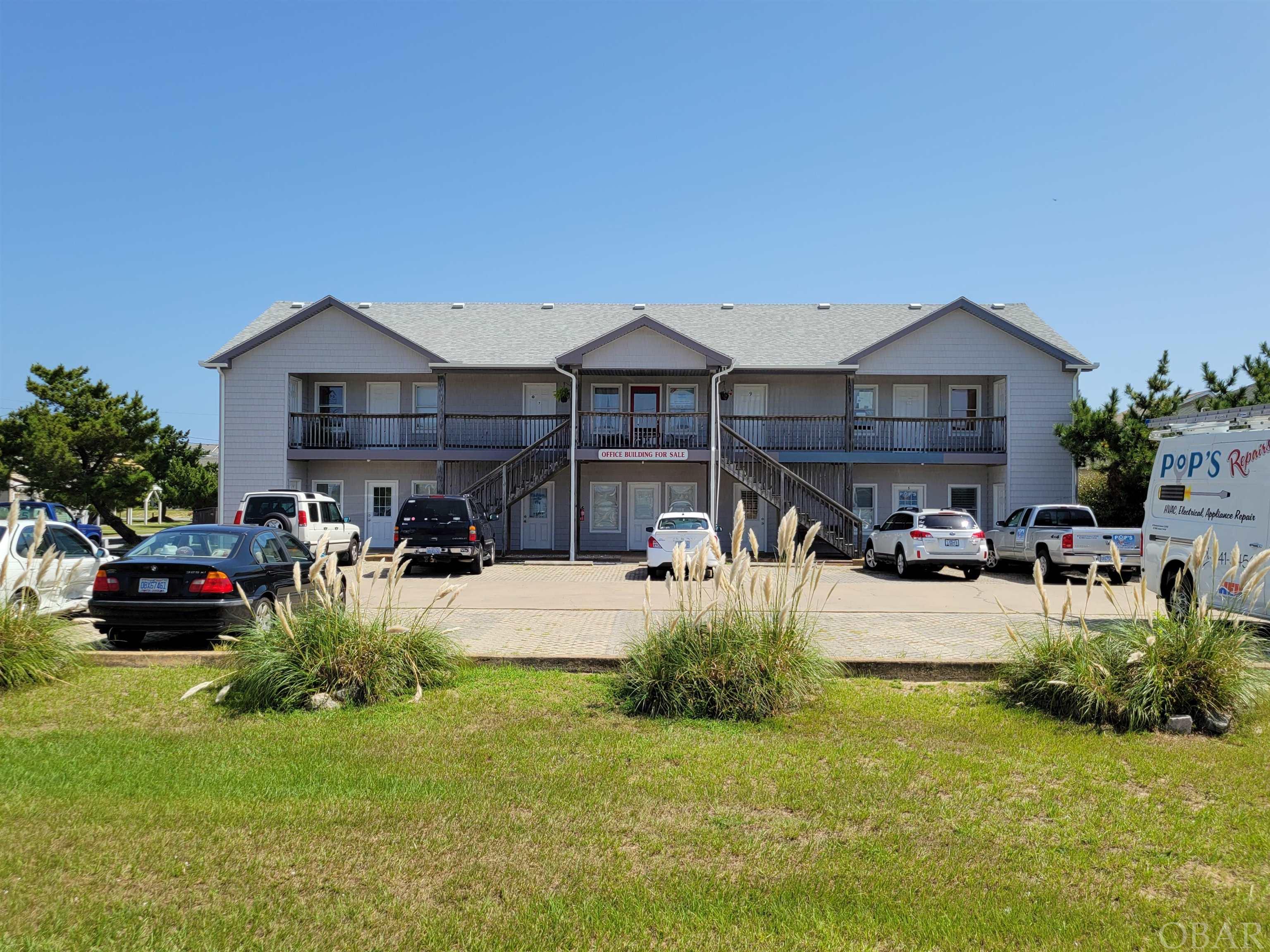 Exceptionally clean and well maintained commercial office space.  10 Unit office space, 100% occupied… all the work is done!  Located in Kill Devil Hills on the east side of the 158 Bypass this building consists of 5 ground floor units and 5 second floor units.  All units have front and rear doors, and side by side spaces can interconnect.  Currently 7 different businesses occupy all 10 units and everyone is happy and wants to stay!  Tenants pay for electricity and cable, owner pays all other utilities and taxes.  Owner financing available; 10% down; 4% interest; 30 year term with a 10 year balloon payment.