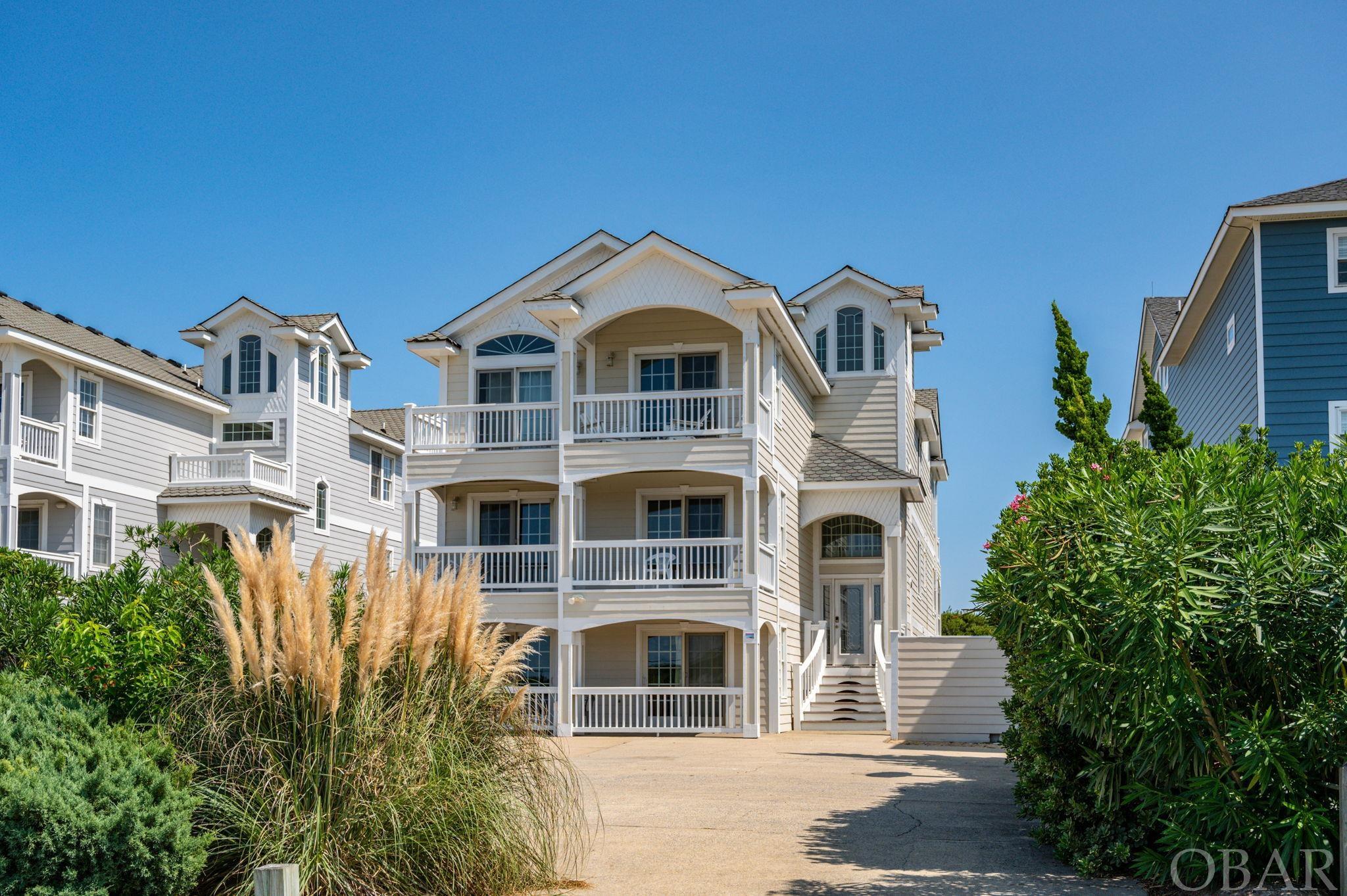 OVER $272,000 BOOKED FOR 2021 IN 31 WEEKS AND $279,380 PRE-BOOKED FOR 2022 IN JUST 28 WEEKS! THIS HOUSE WILL DO OVER $280K. Oceanfront estate with ten bedrooms and amenities galore. Over 5,800 square feet of heated living area. RECENT UPDATES INCLUDE: Three new HVAC units Installed inside and outside 2018. New Exterior paint 2019-2020. New Water Heaters 2020. New Kitchen Appliances 2019. Designed to impress, this grand home offers stylish furnishings and upgrades, an elevator, luxurious master suites with private baths and sensational entertainment options on each level. Centrally located in the town of Kill Devil Hills, guests have easy access to historic landmarks, national parks, family recreation and a multitude of dining and shopping opportunities. The ground floor features a well-equipped recreation room with regulation size pool table, foosball table, plush sofa seating, mounted flat screen and a bar with sink, microwave, full refrigerator, icemaker, dishwasher and bar seating. A private home theater with tiered seating, a projection screen and surround sound, creates an in-house cinematic experience. Soaring ceilings, class columns, shimmering ceramic tile and elegant furnishings greet you as you ascend to the top level. A grand king master suite completes the top floor and has a private balcony the best place to catch a sunset, sitting area, seasonal fireplace, flat screen TV, mini refrigerator and a Jacuzzi tub living space all of its own, with a waterfall, sculpted pool, hot tub and cabana bar with bathroom and rooftop sundeck. The volleyball area will keep the athletes entertained, while an exterior speaker system ensures that the music is always playing. Ample outdoor furniture allows for lounging under sunny coastal skies. Don't forget the boardwalk to you own private beach access!!!